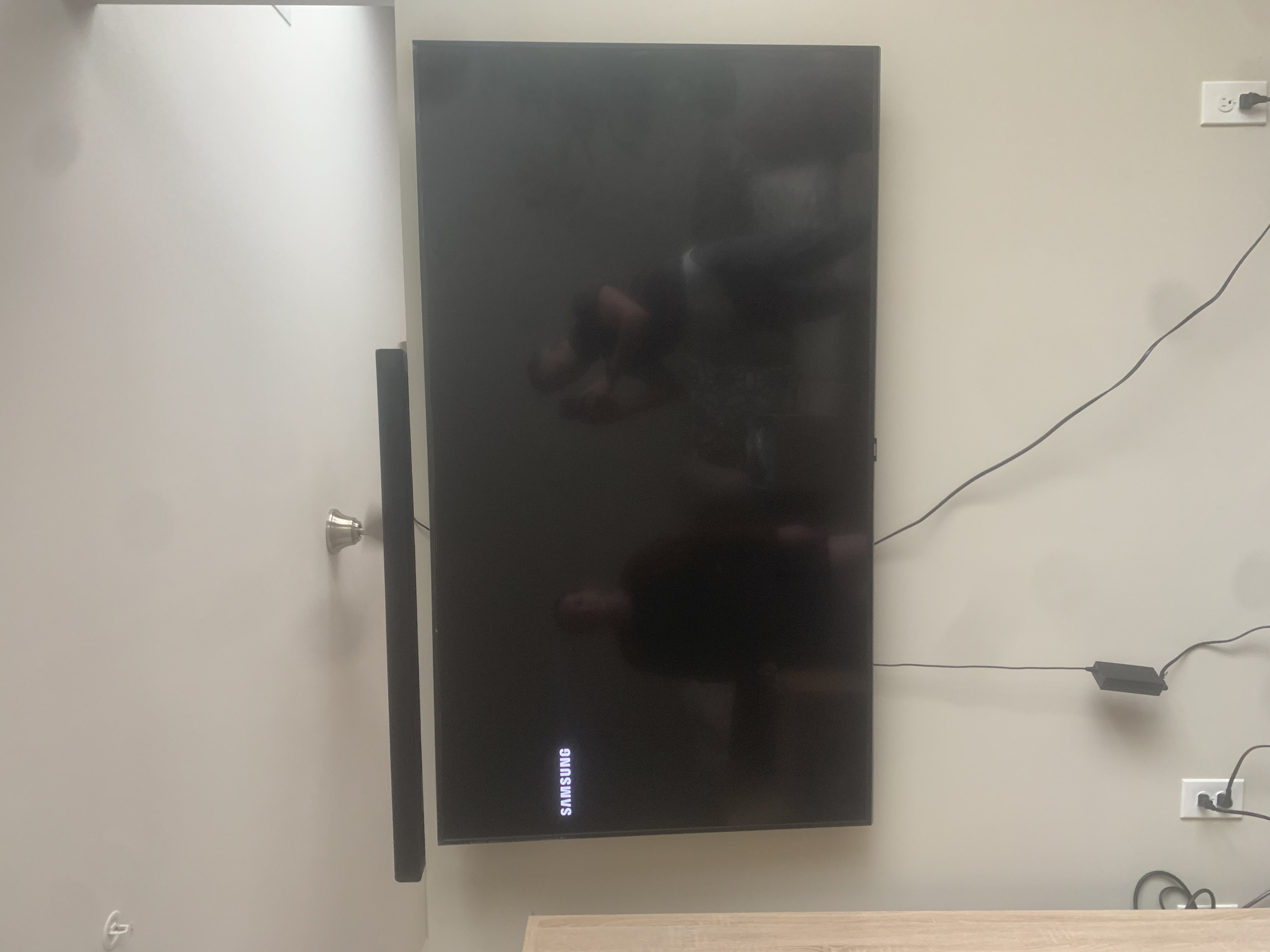 Tilting TV mounting on drywall wall in living room, service area