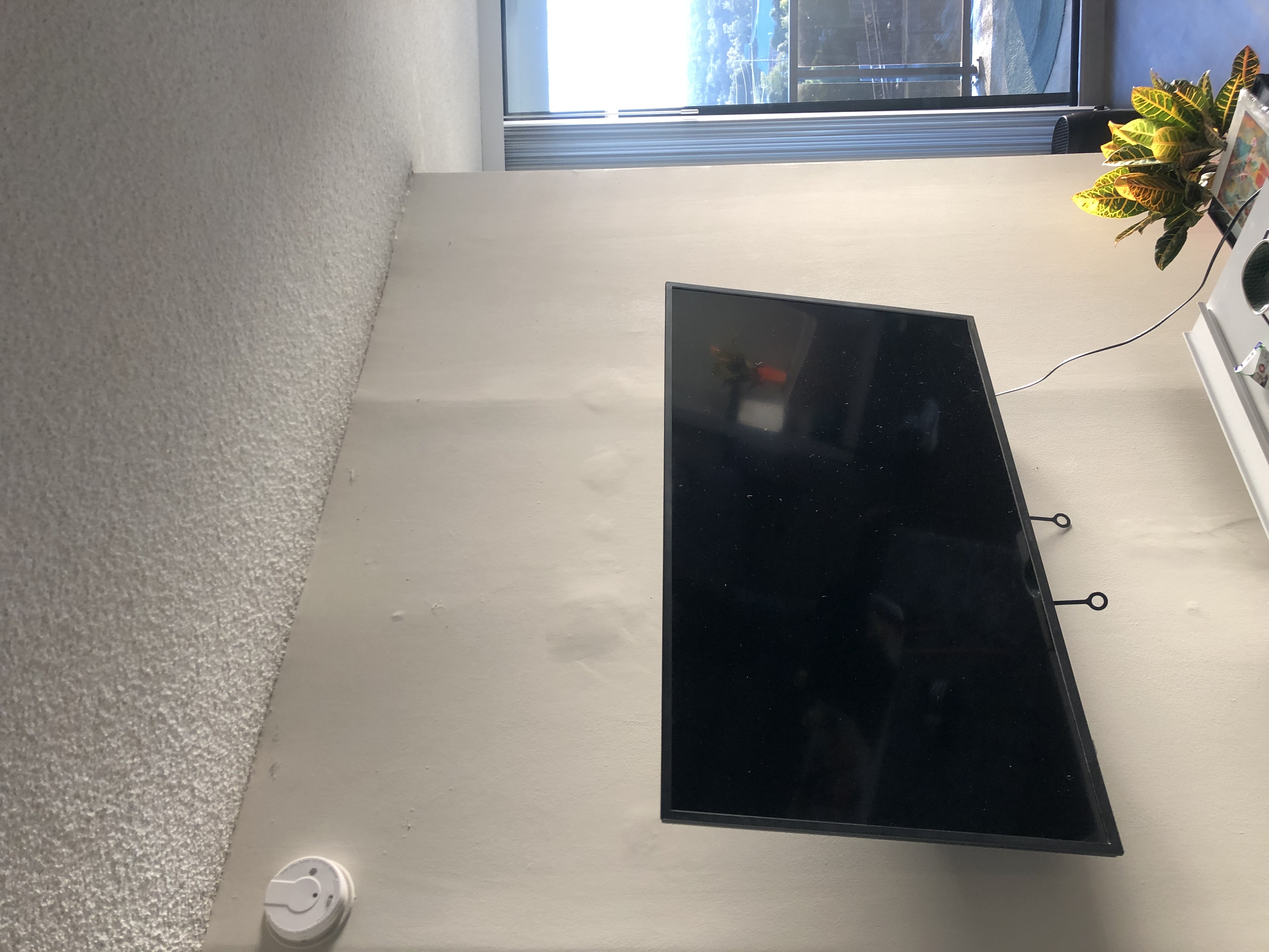 Fixed TV mounting on drywall wall in living room, service area