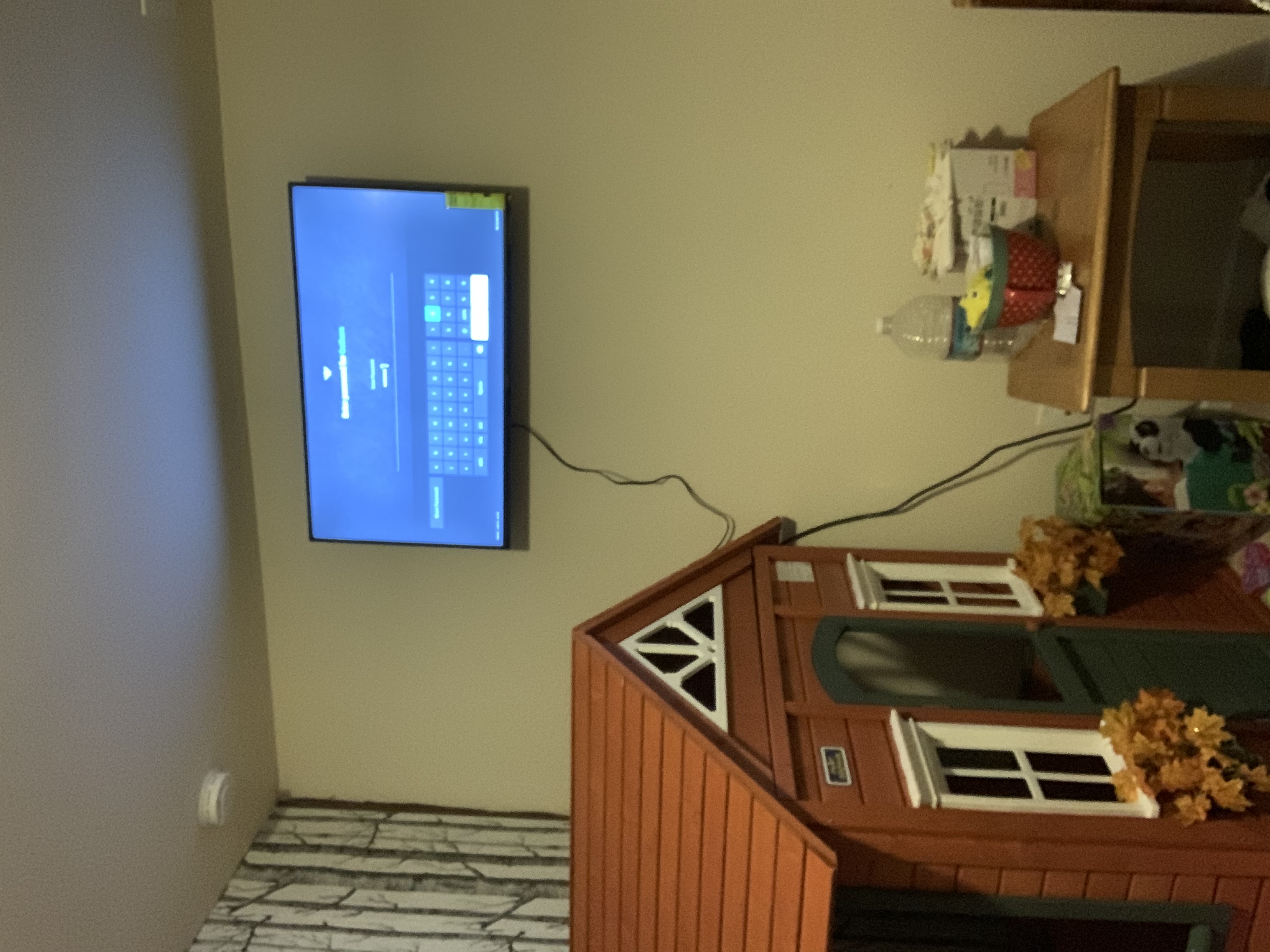 Tilting TV mounting on drywall wall in living room, service area