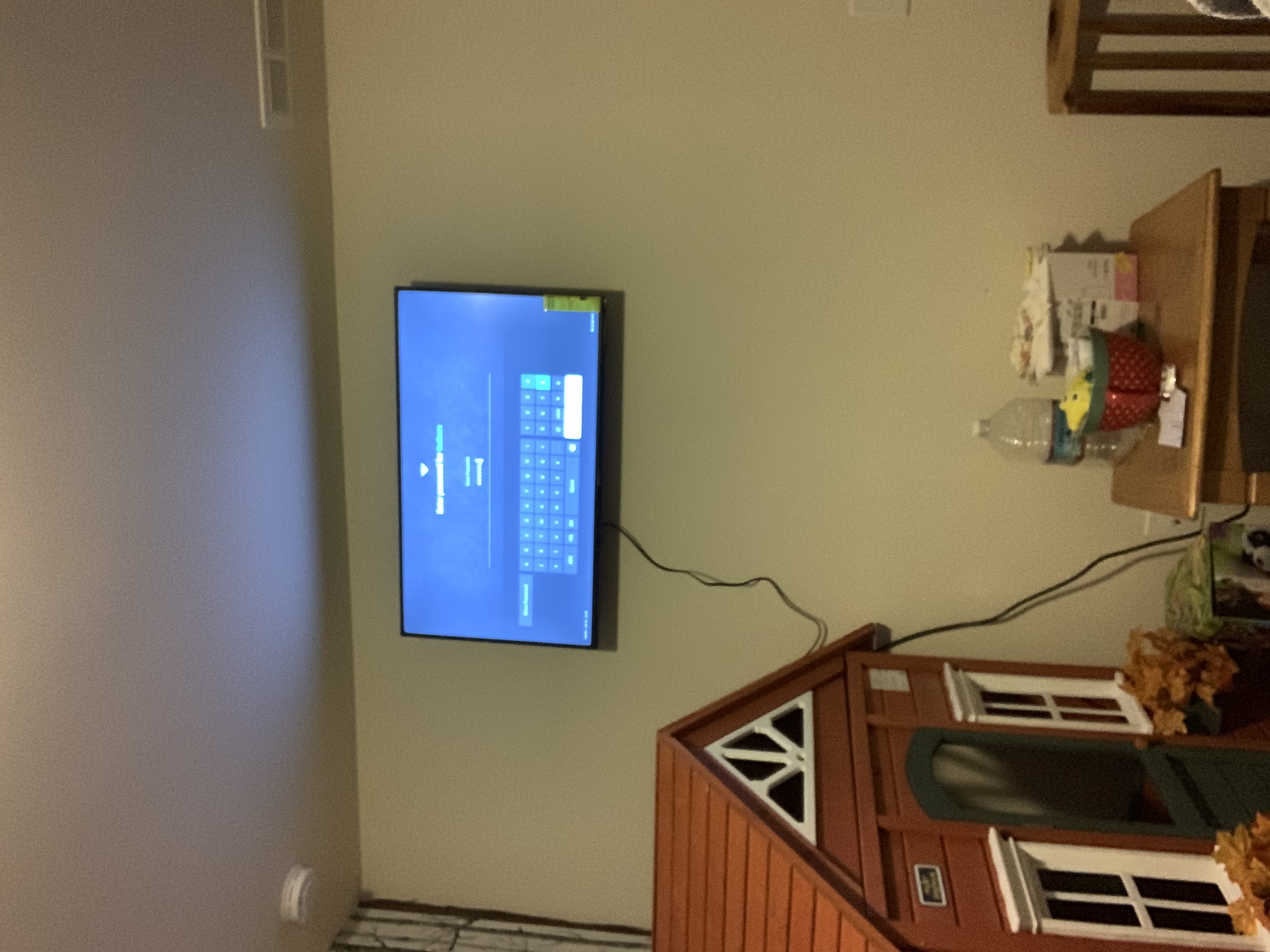Fixed TV mounting on drywall wall in living room, service area