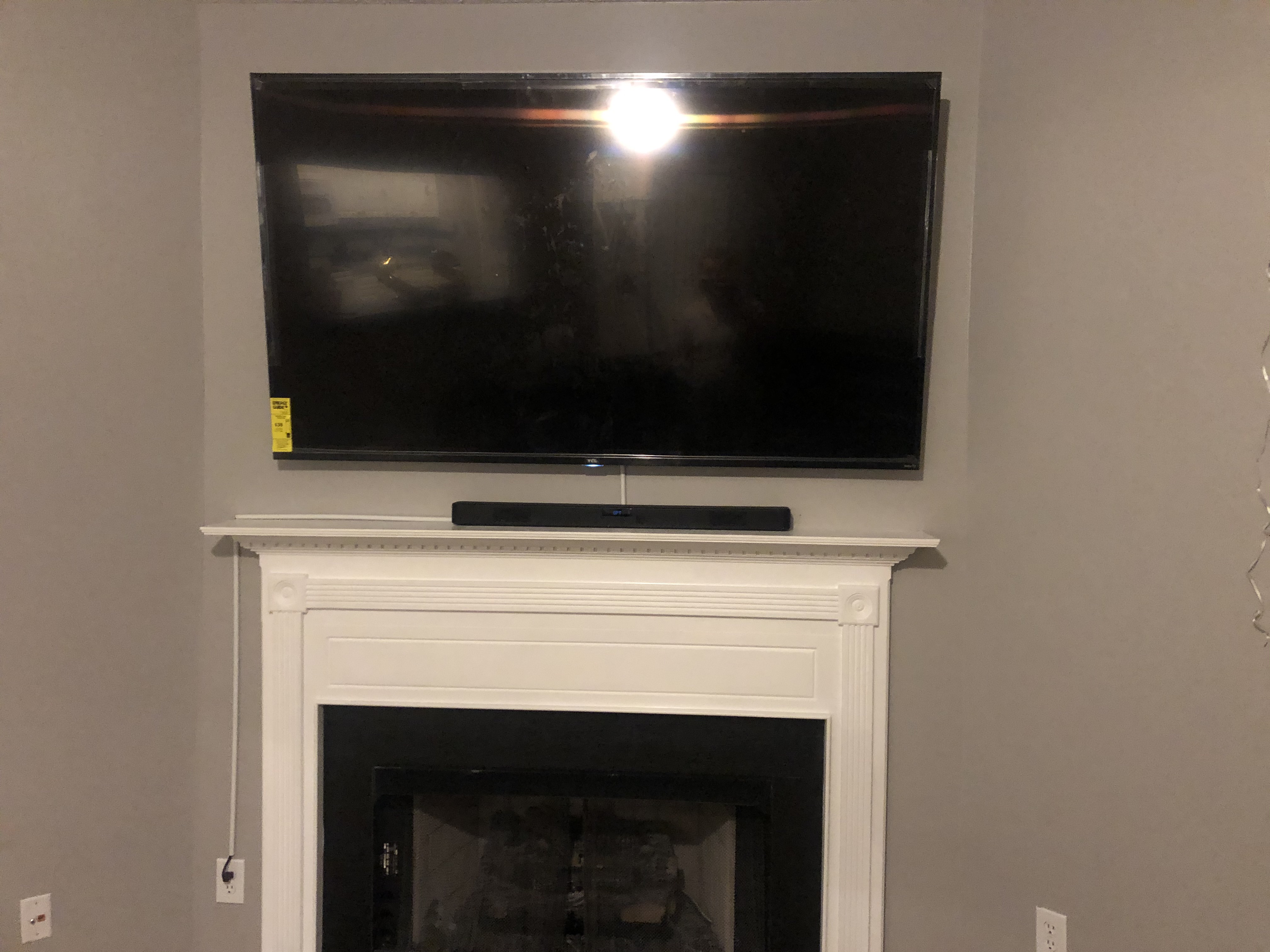 Full-motion TV mounting on drywall wall in living room, service area