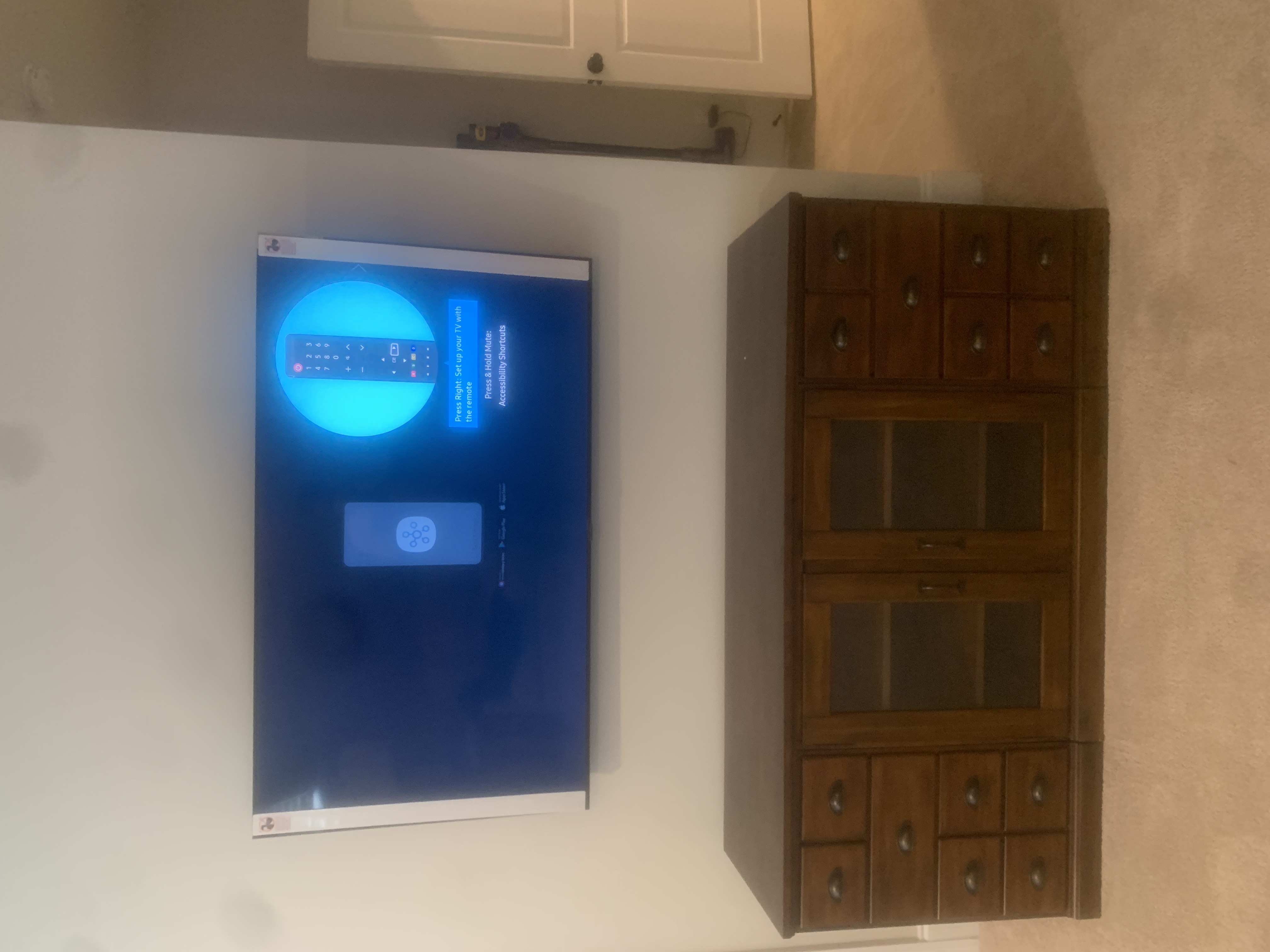 Tilting TV mounting on drywall wall in living room, service area