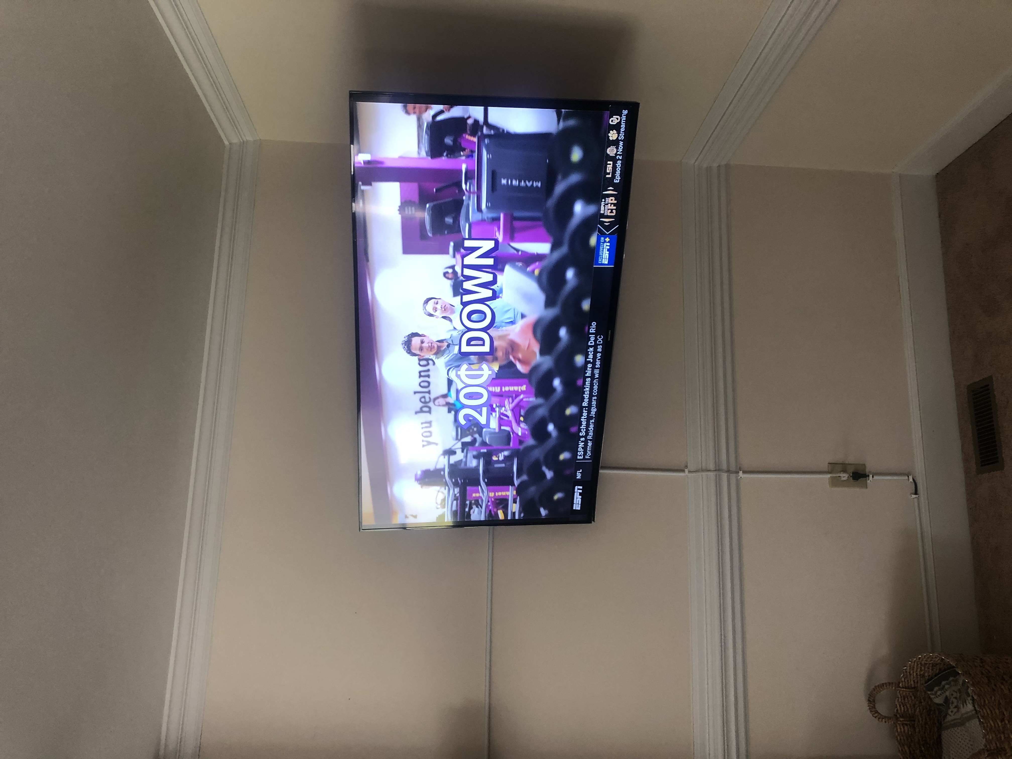 Full-motion TV mounting on drywall wall in living room, service area