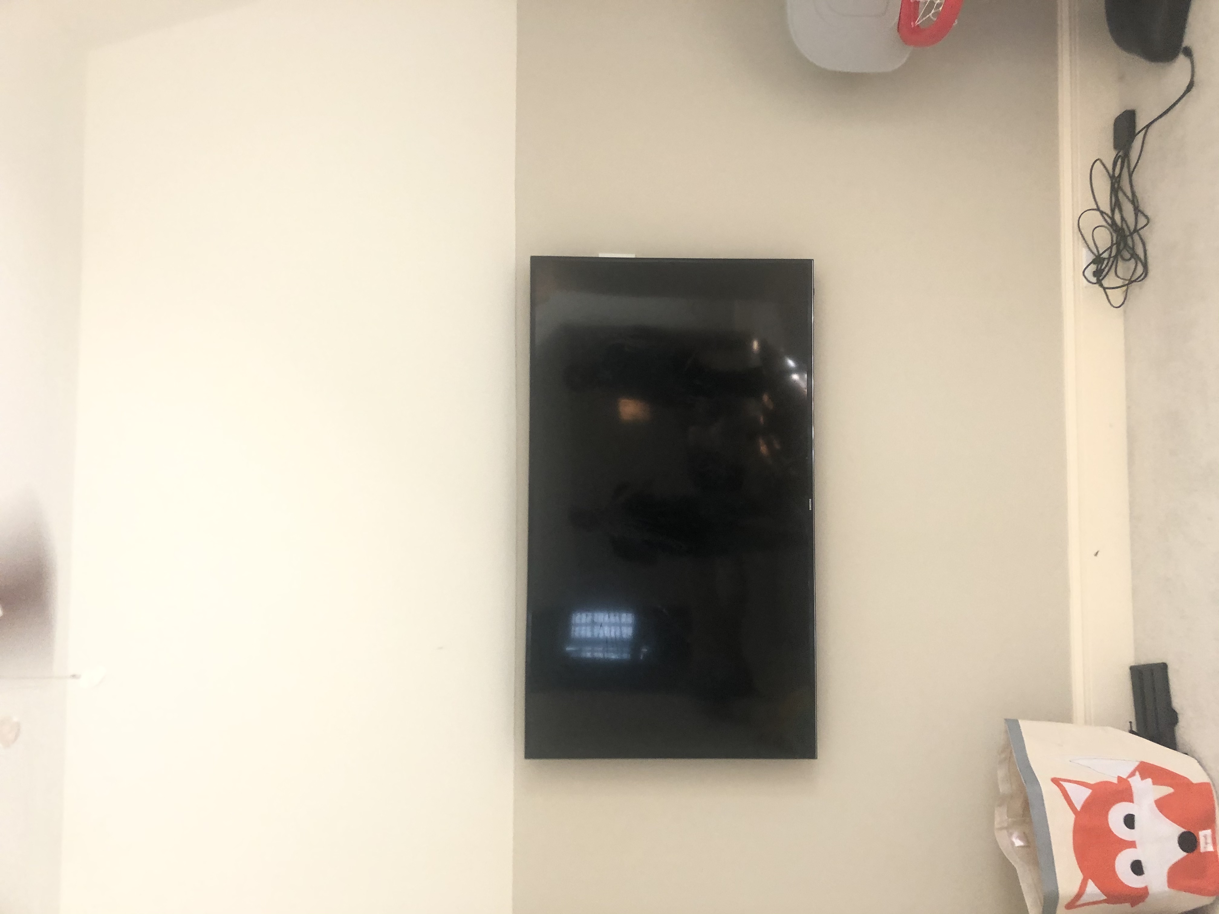 Fixed TV mounting on drywall wall in living room, service area