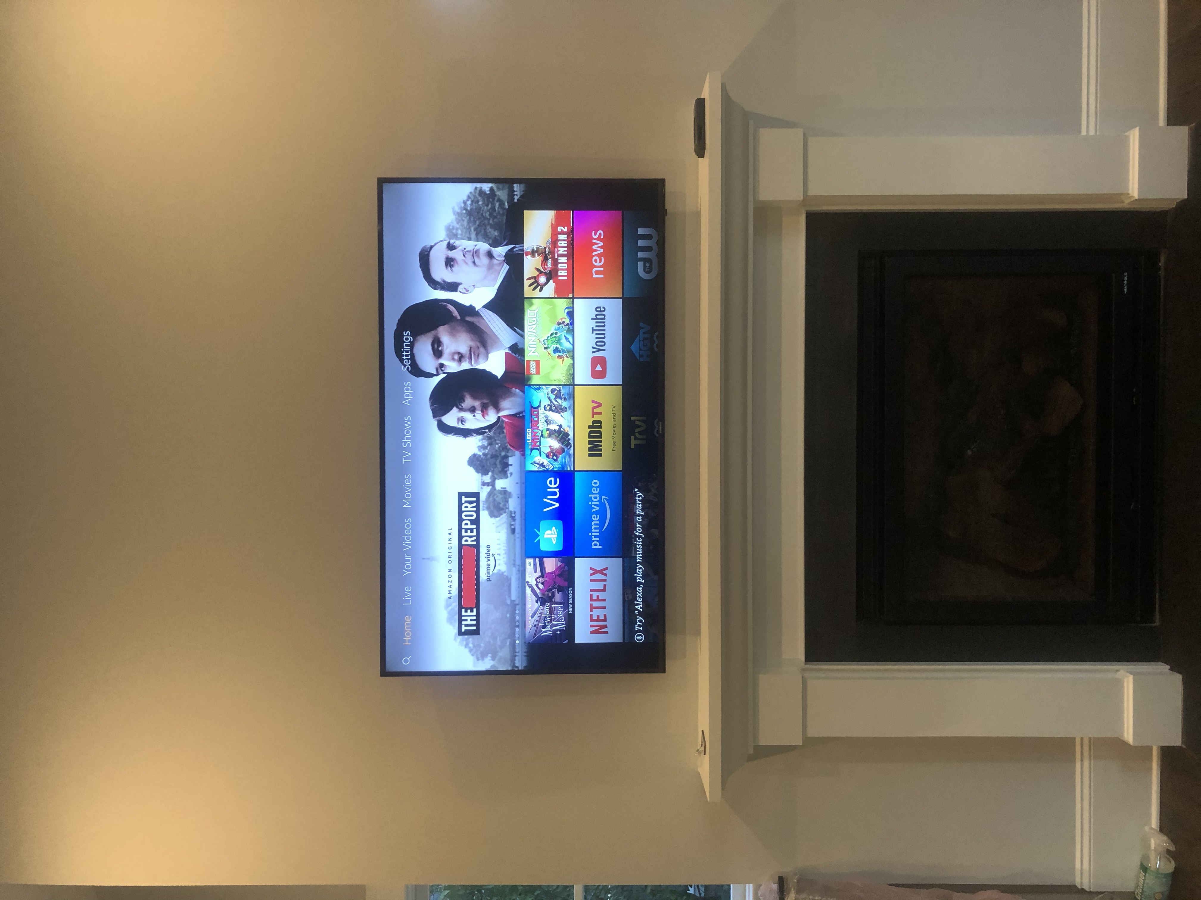 Full-motion TV mounting on drywall wall in living room, service area
