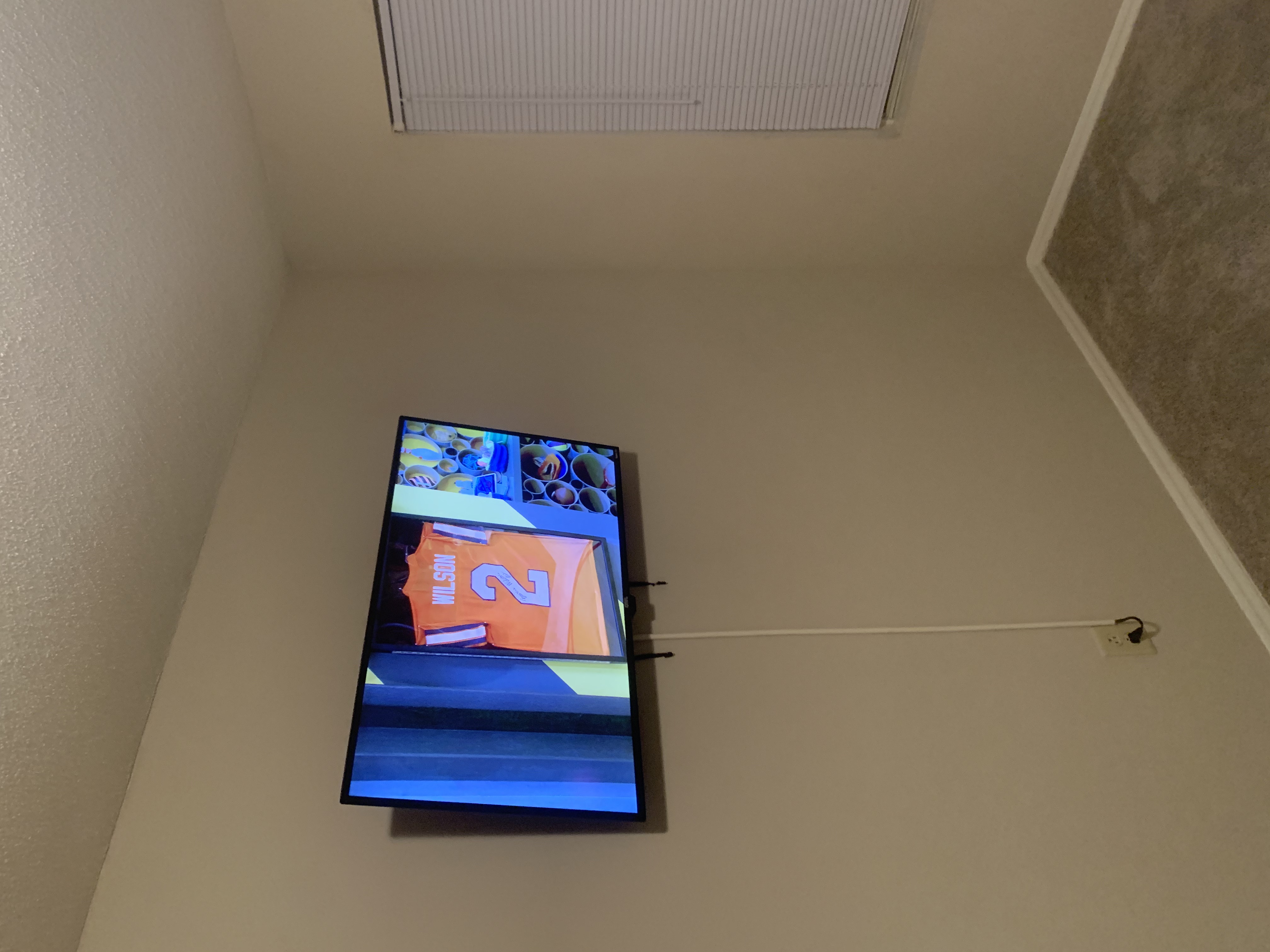 Fixed TV mounting on drywall wall in living room, service area