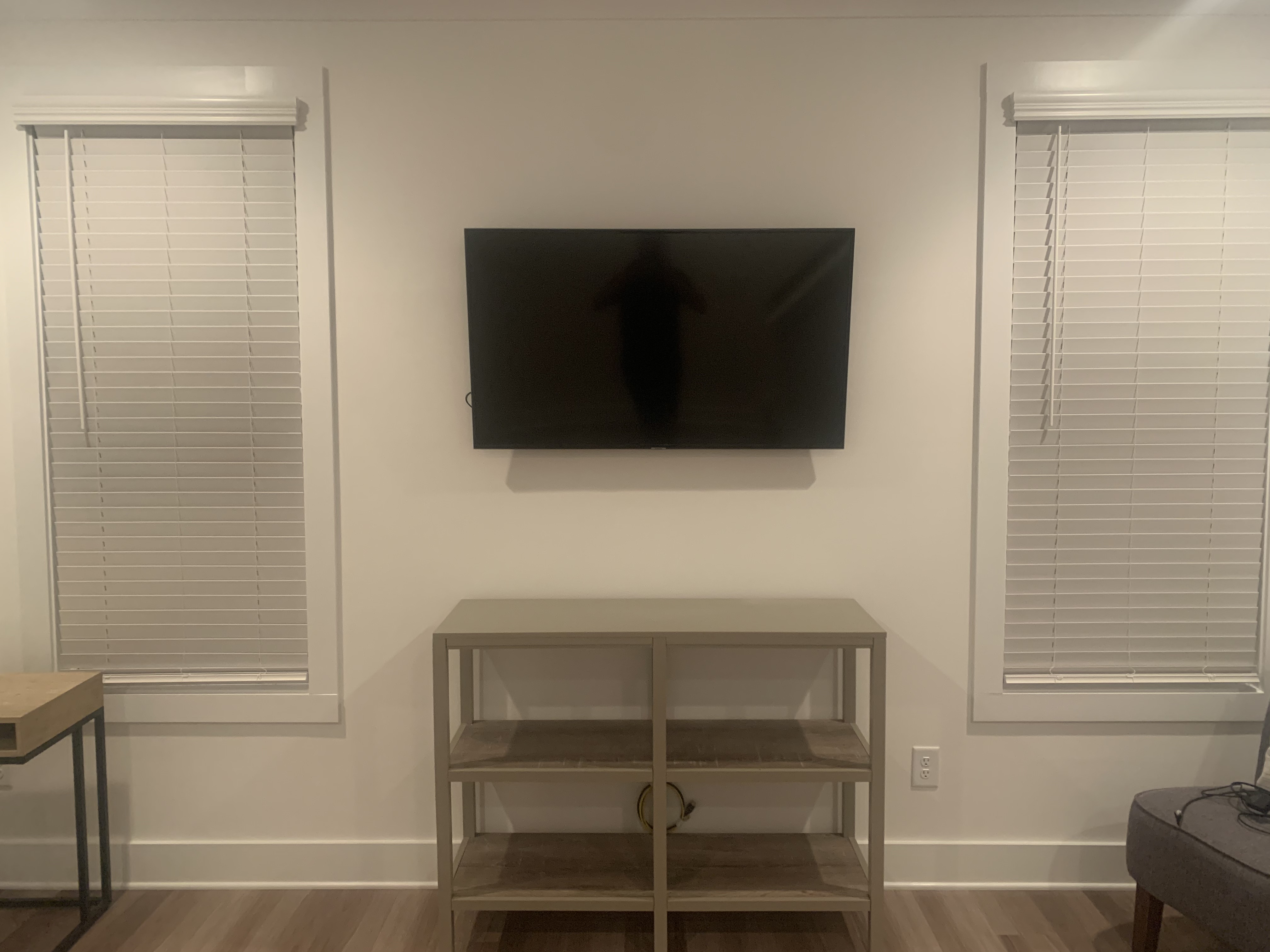 Full-motion TV mounting on drywall wall in living room, Charlotte NC