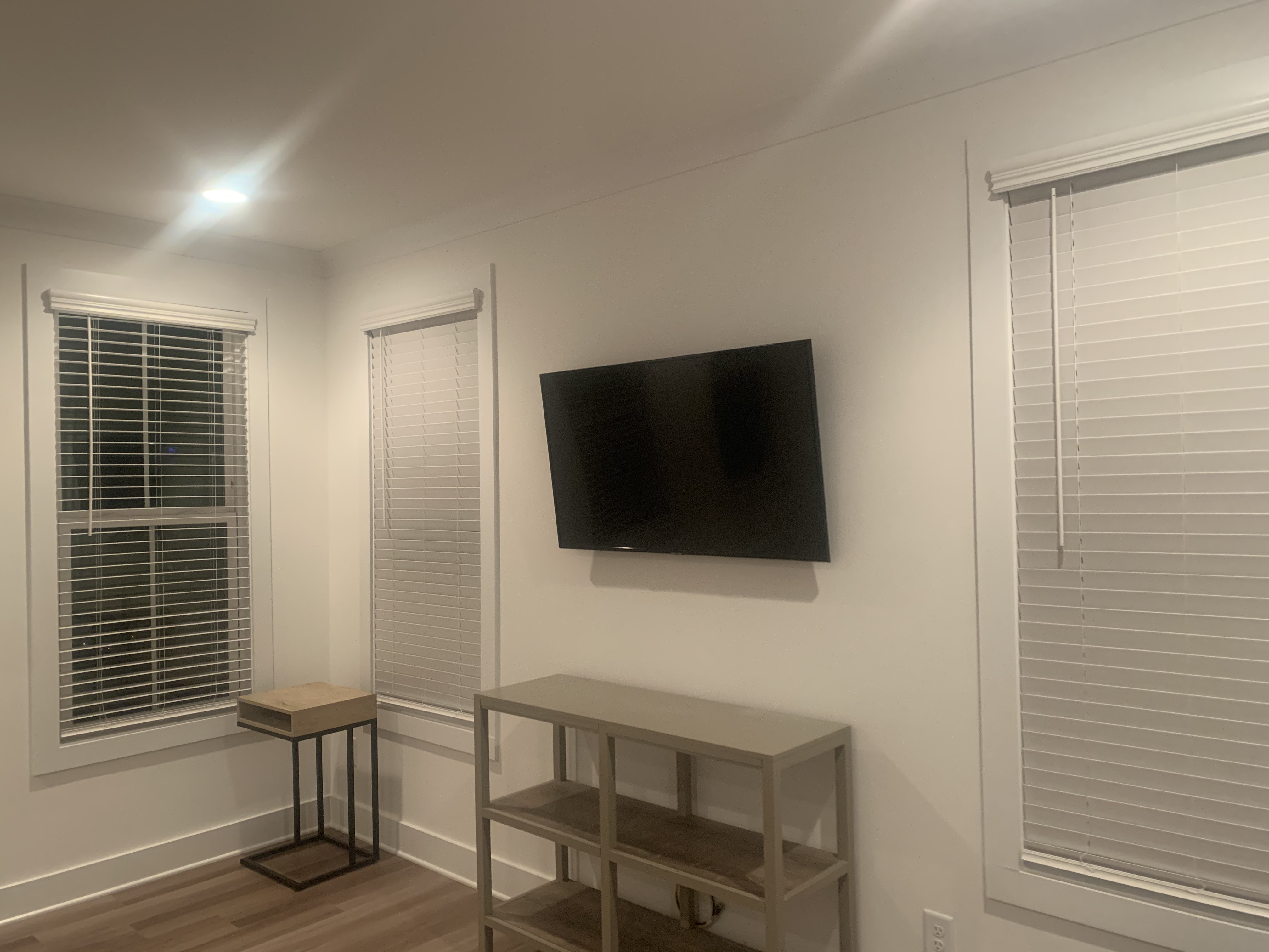 Fixed TV mounting on drywall wall in living room, service area