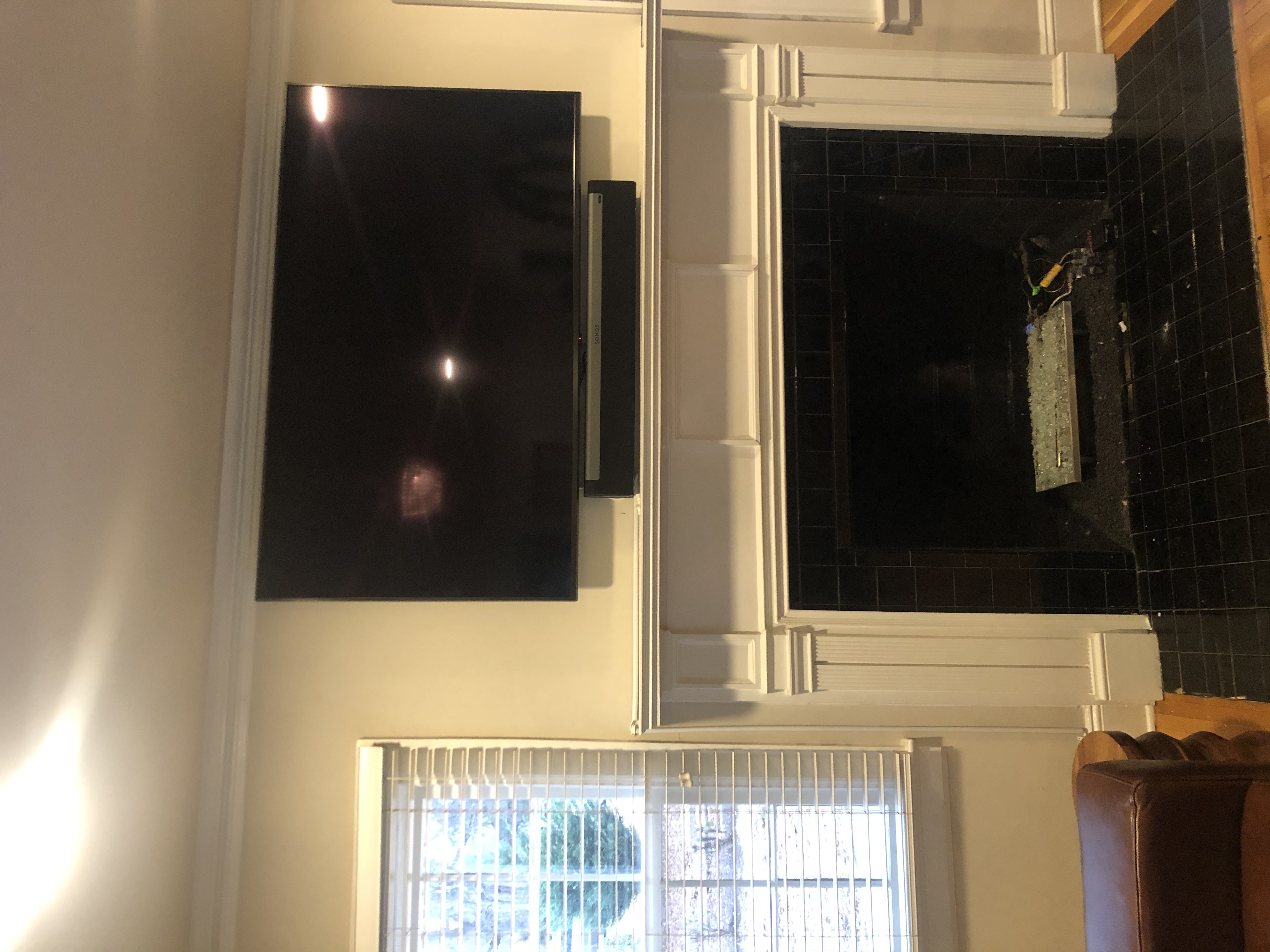 Full-motion TV mounting on drywall wall in living room, Charleston SC