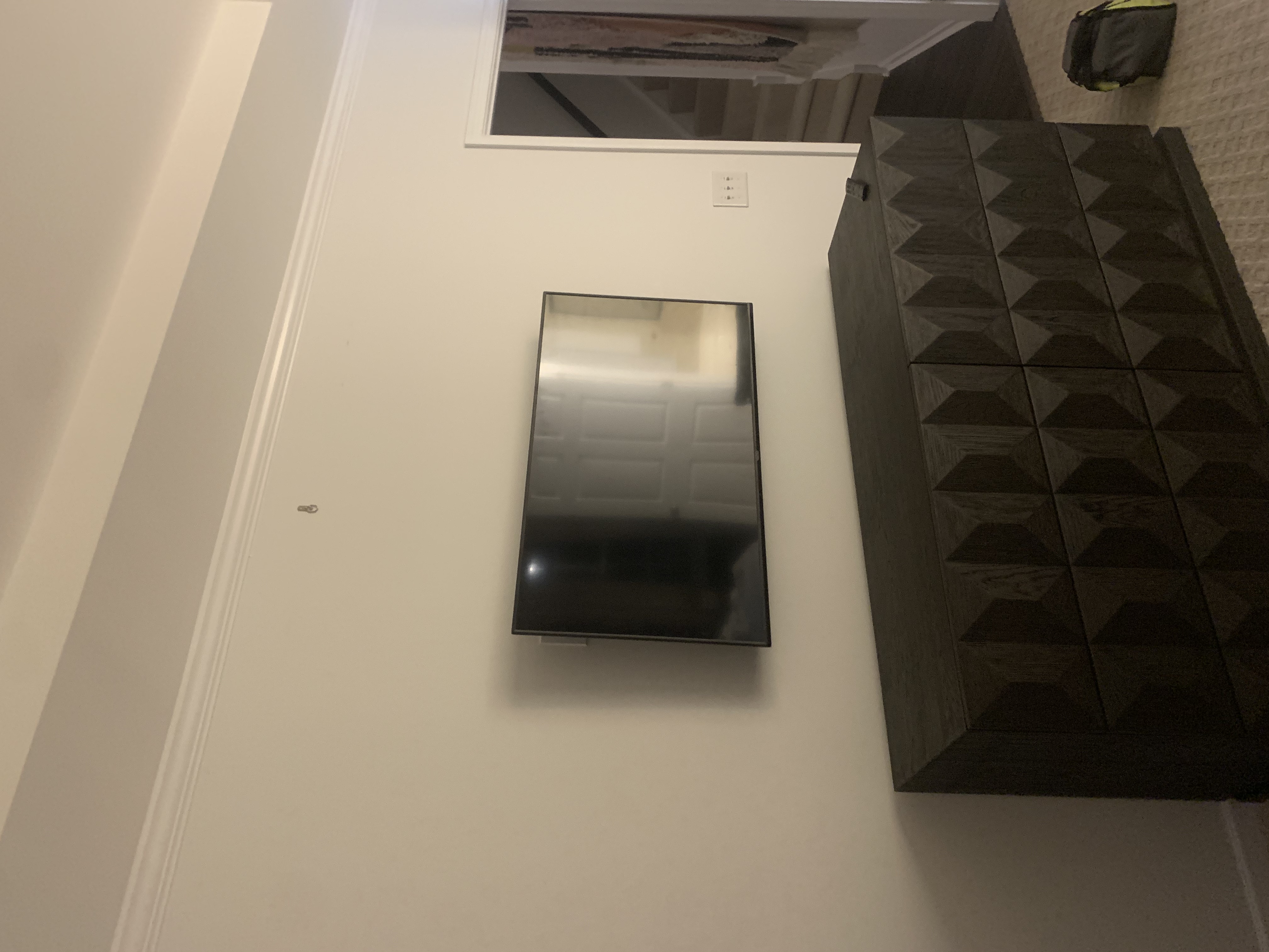Fixed TV mounting on drywall wall in living room, service area