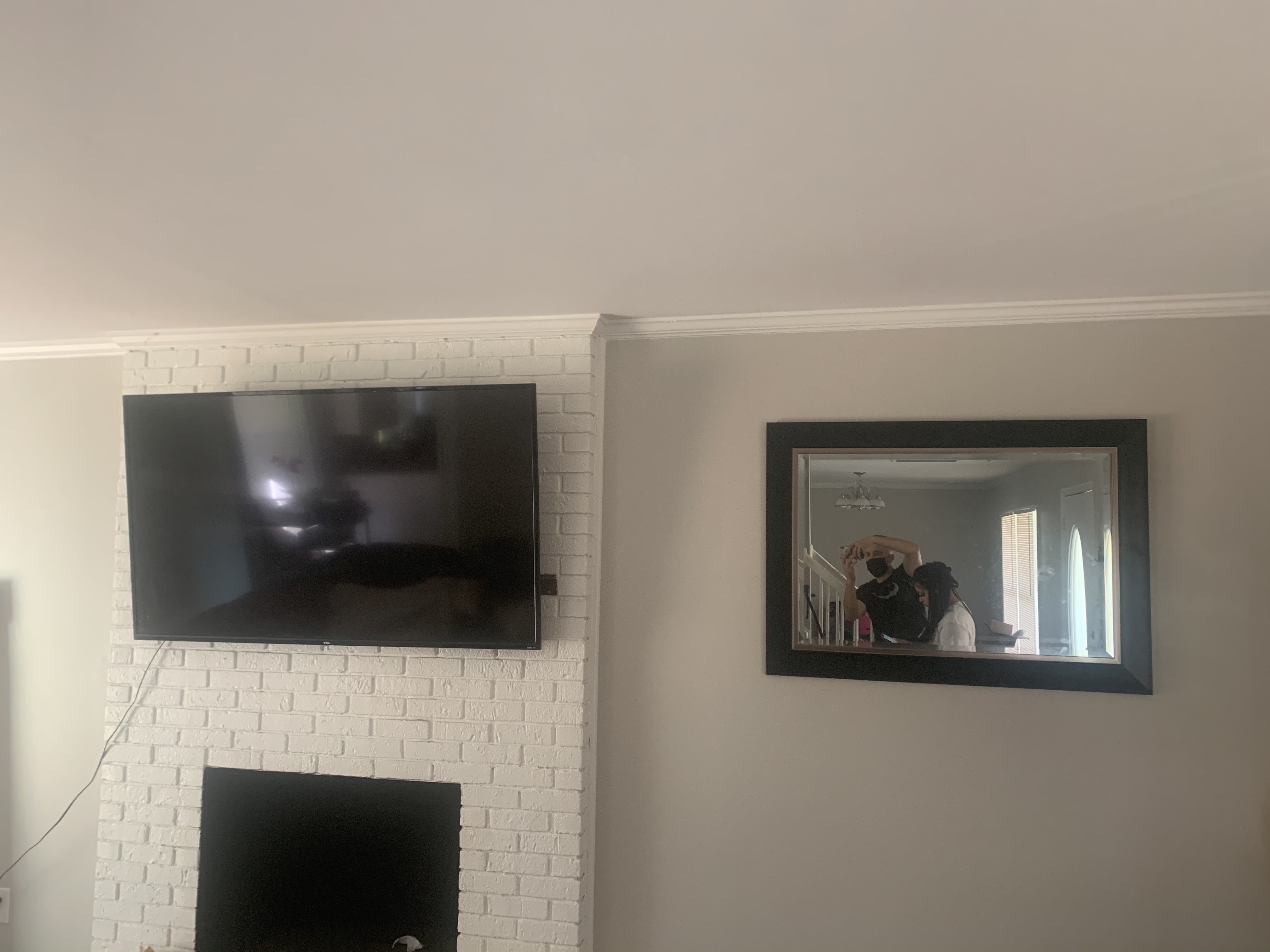 Tilting TV mounting on drywall wall in living room, service area