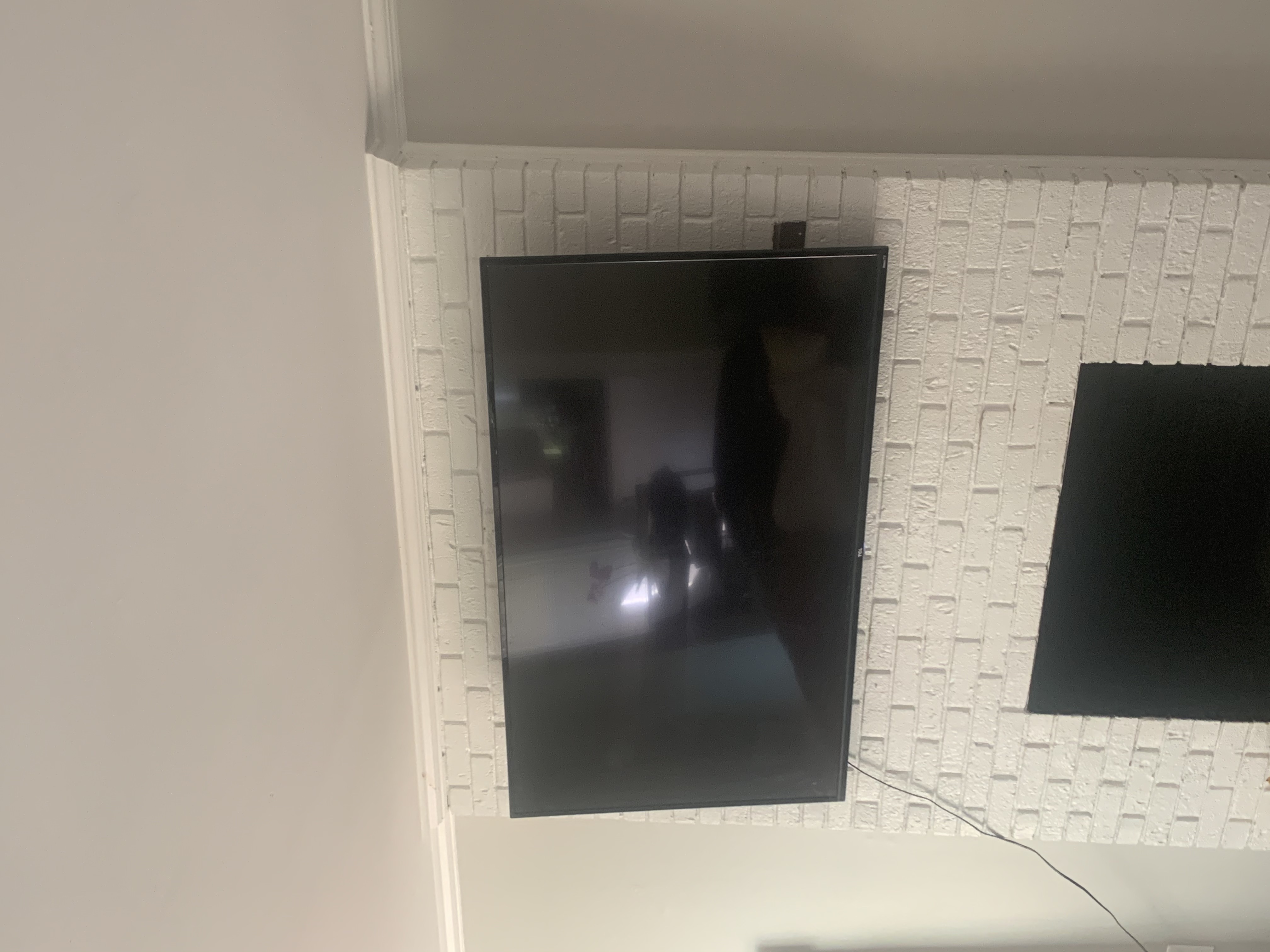 Fixed TV mounting on drywall wall in living room, service area