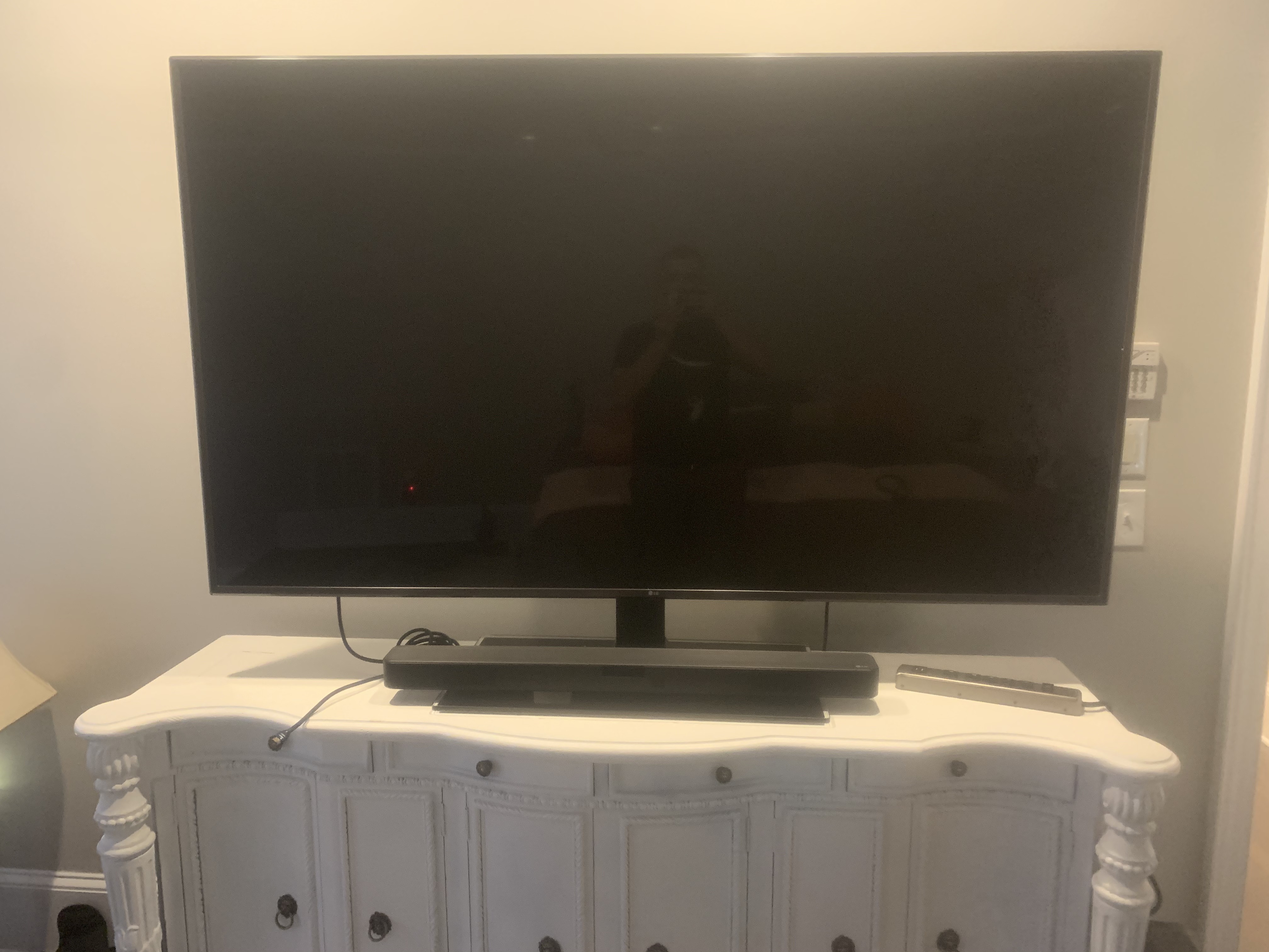 Tilting TV mounting on drywall wall in living room, service area