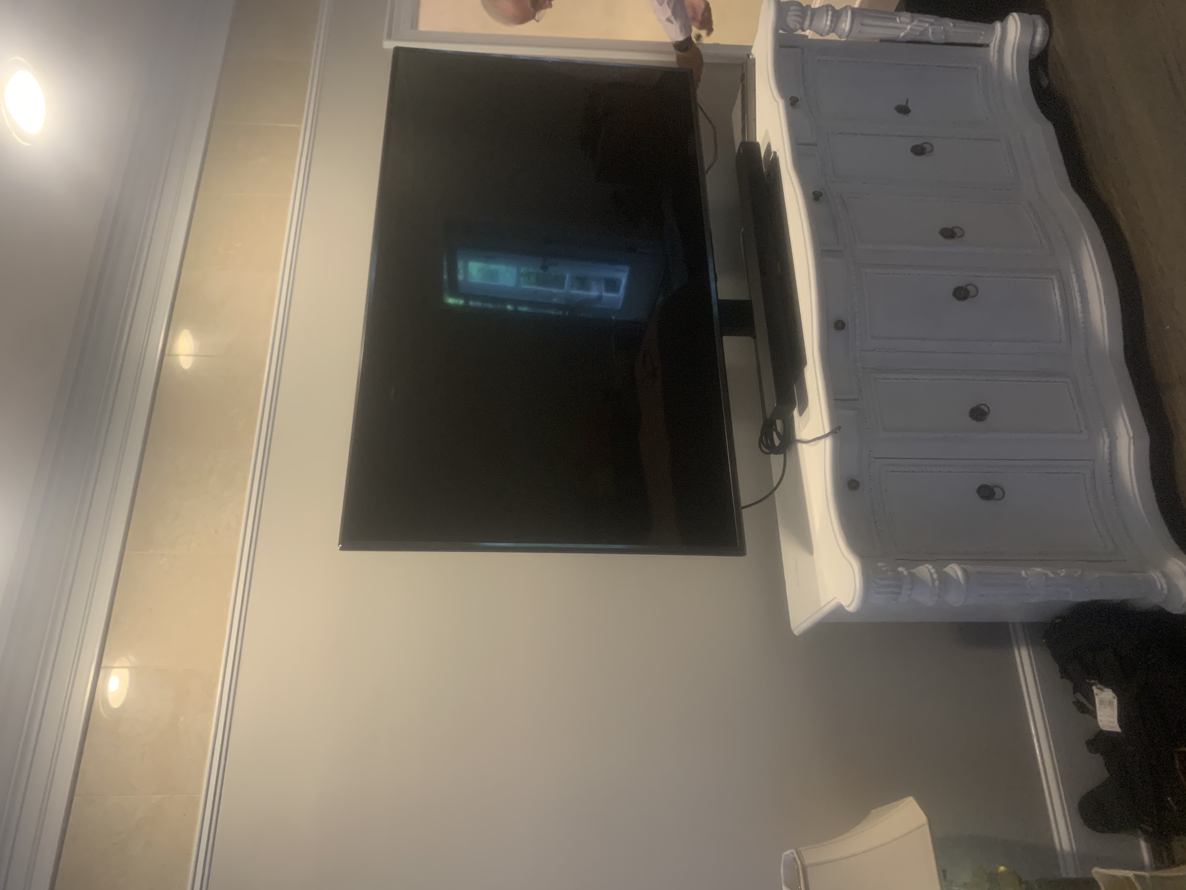 Full-motion TV mounting on drywall wall in living room, service area