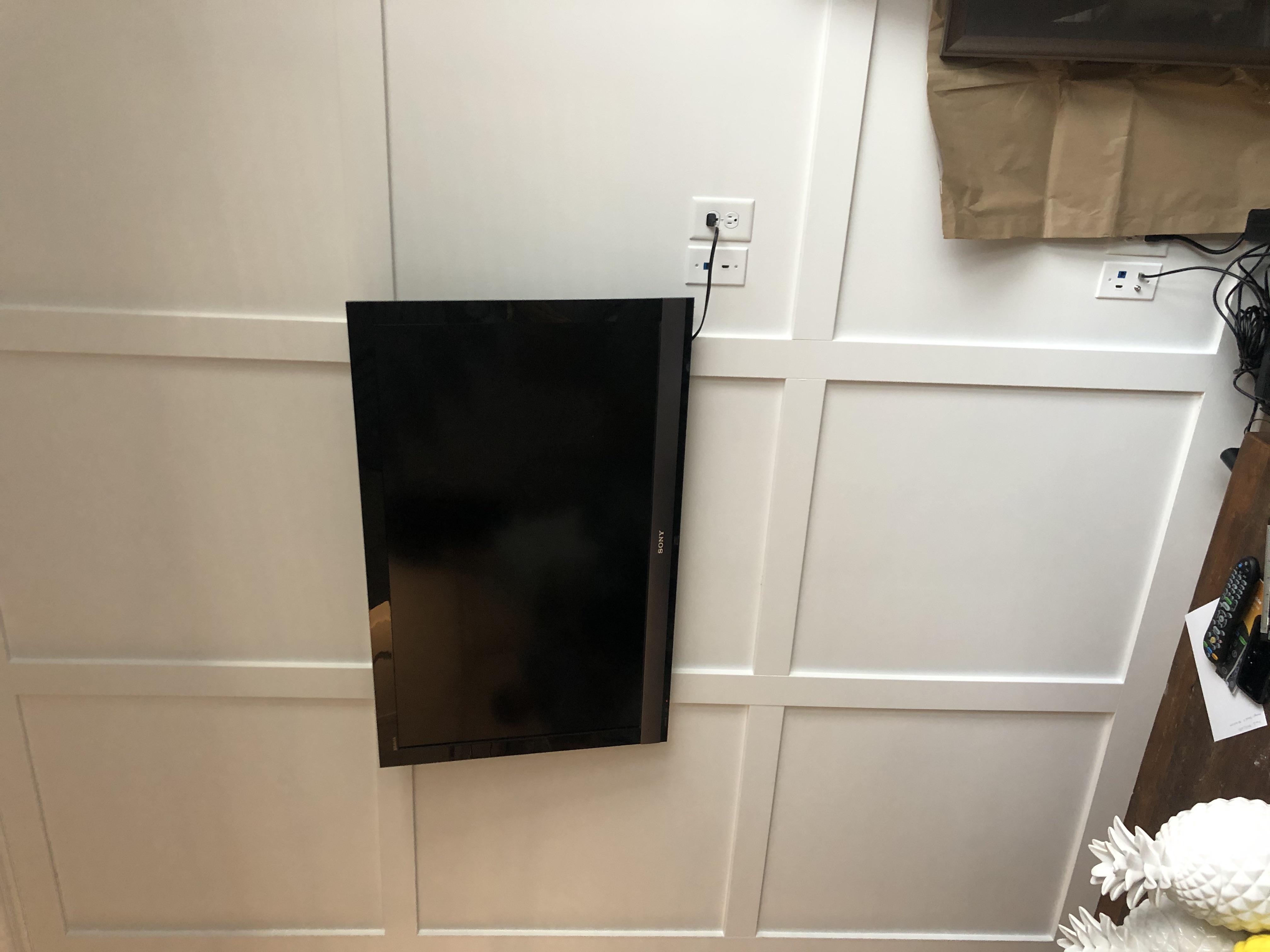 Fixed TV mounting on drywall wall in living room, service area