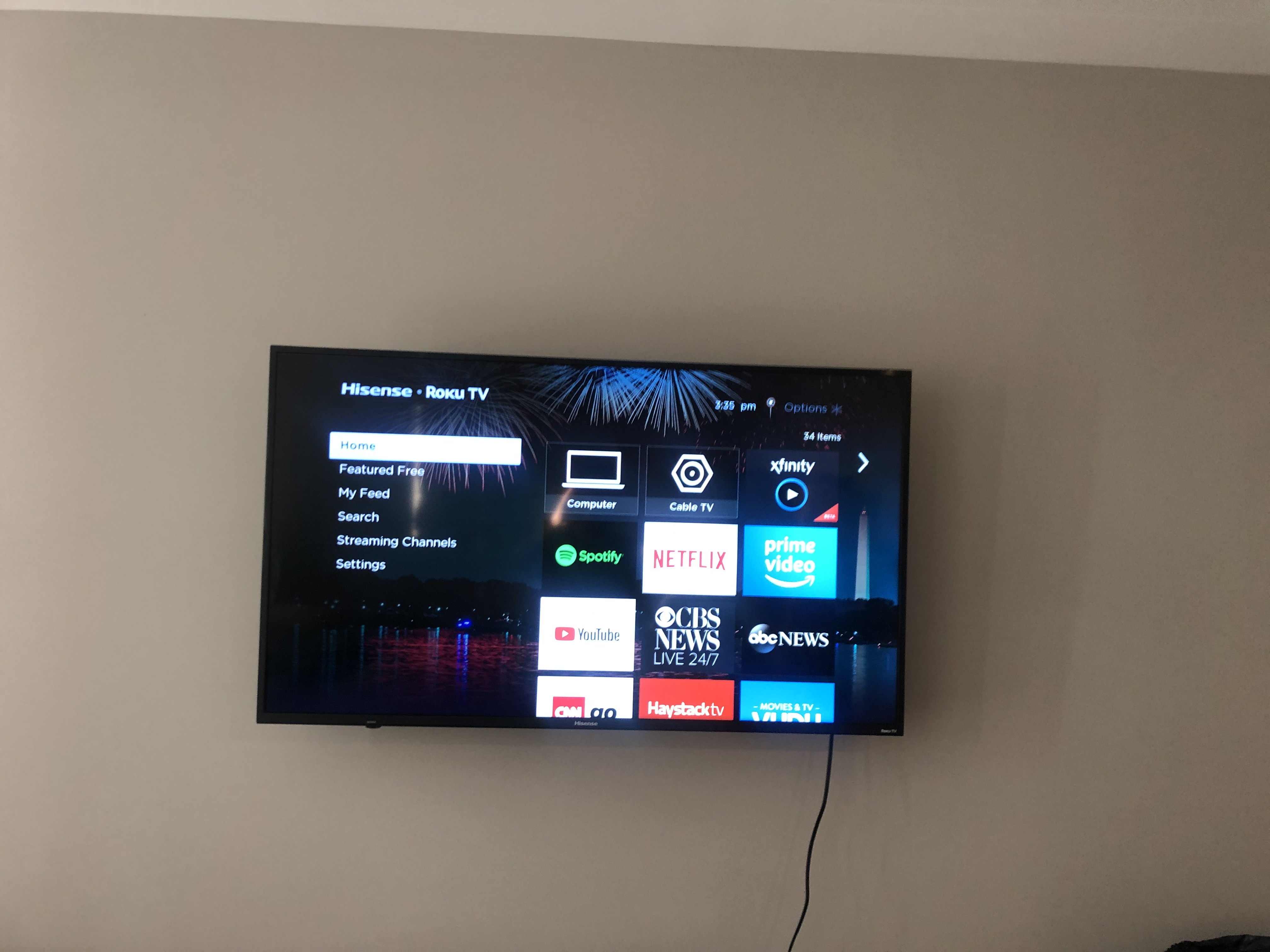 Full-motion TV mounting on drywall wall in living room, service area