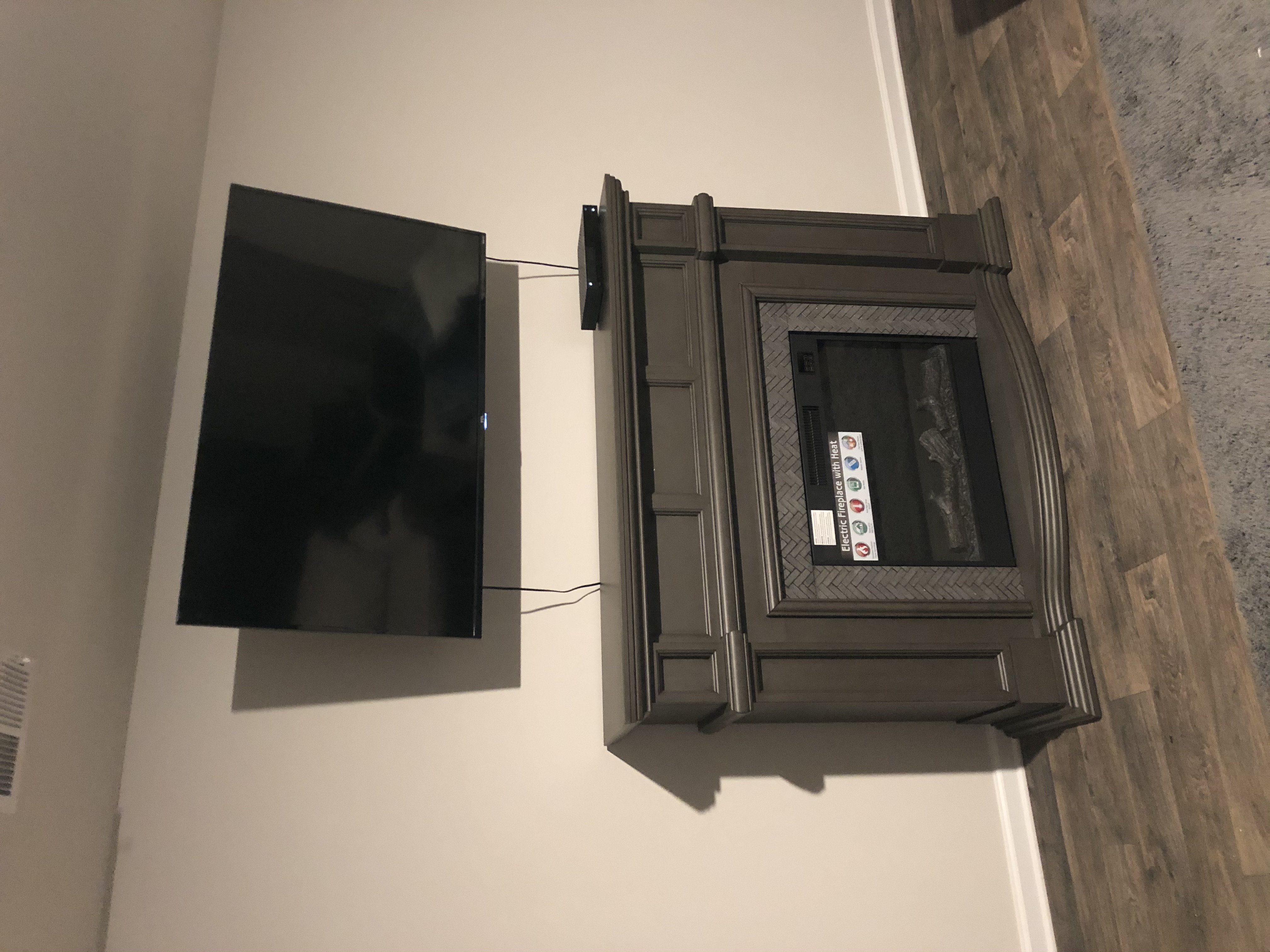 Fixed TV mounting on drywall wall in living room, service area