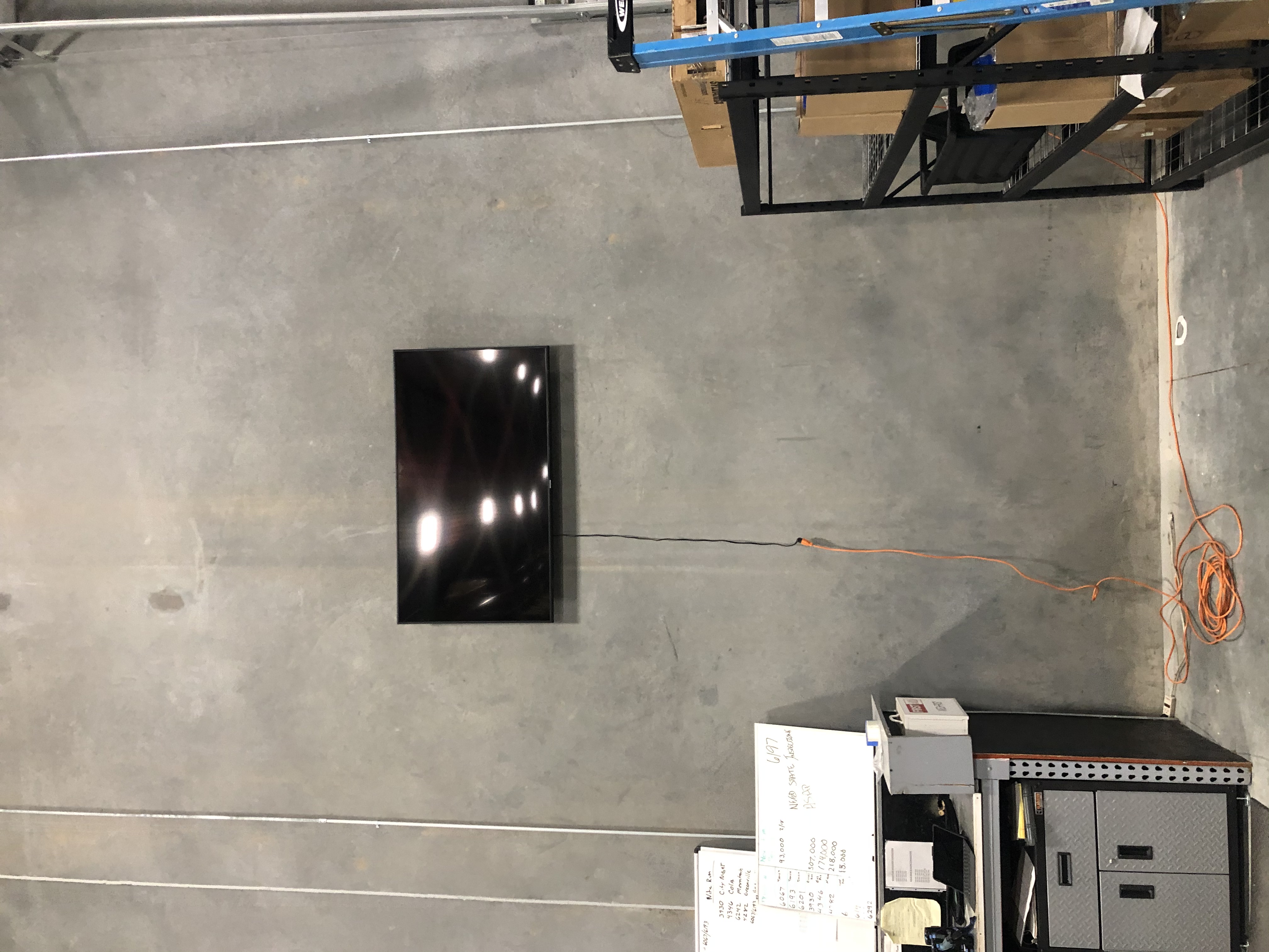 Full-motion TV mounting on drywall wall in living room, service area