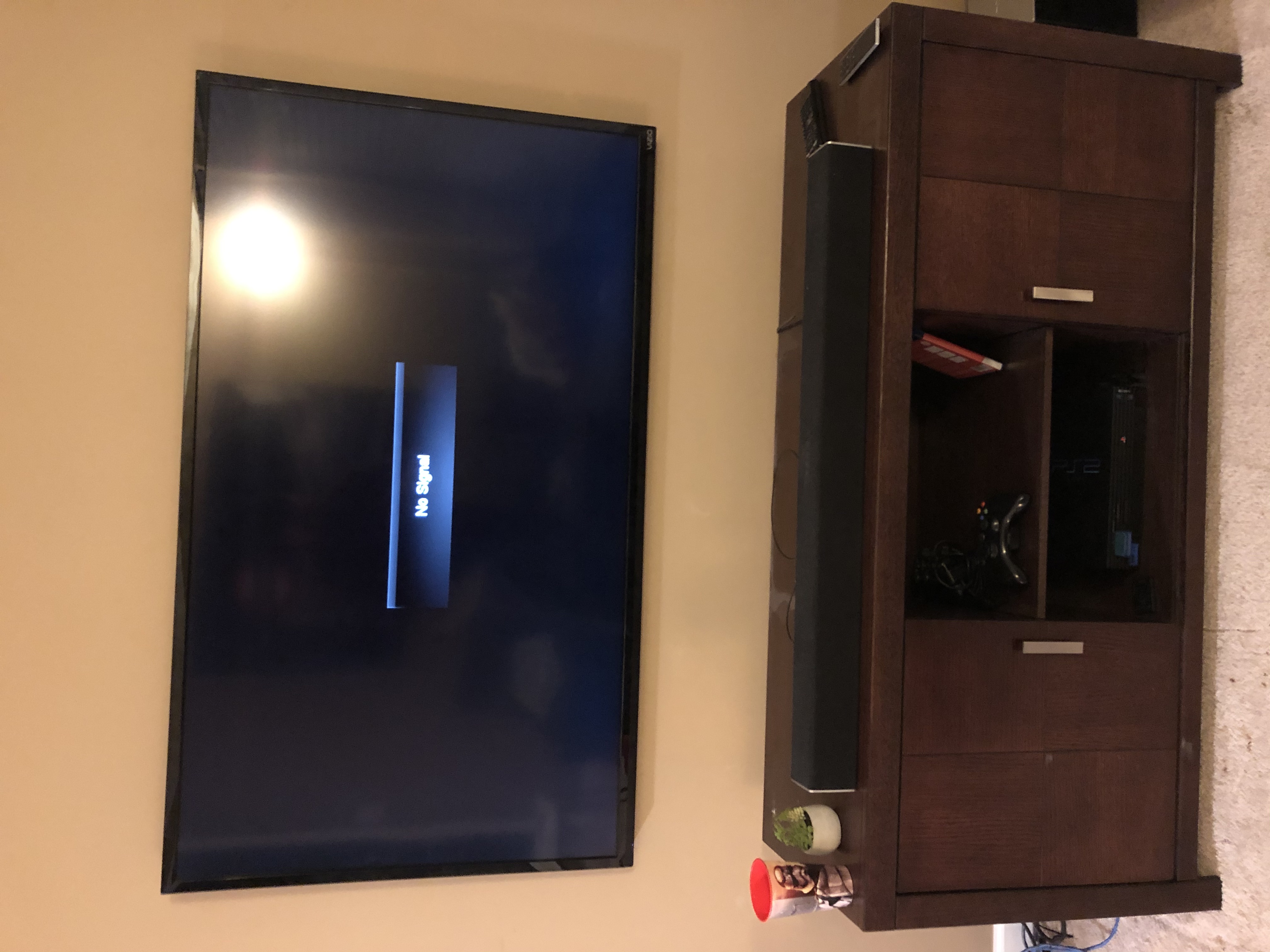 Tilting TV mounting on drywall wall in living room, service area