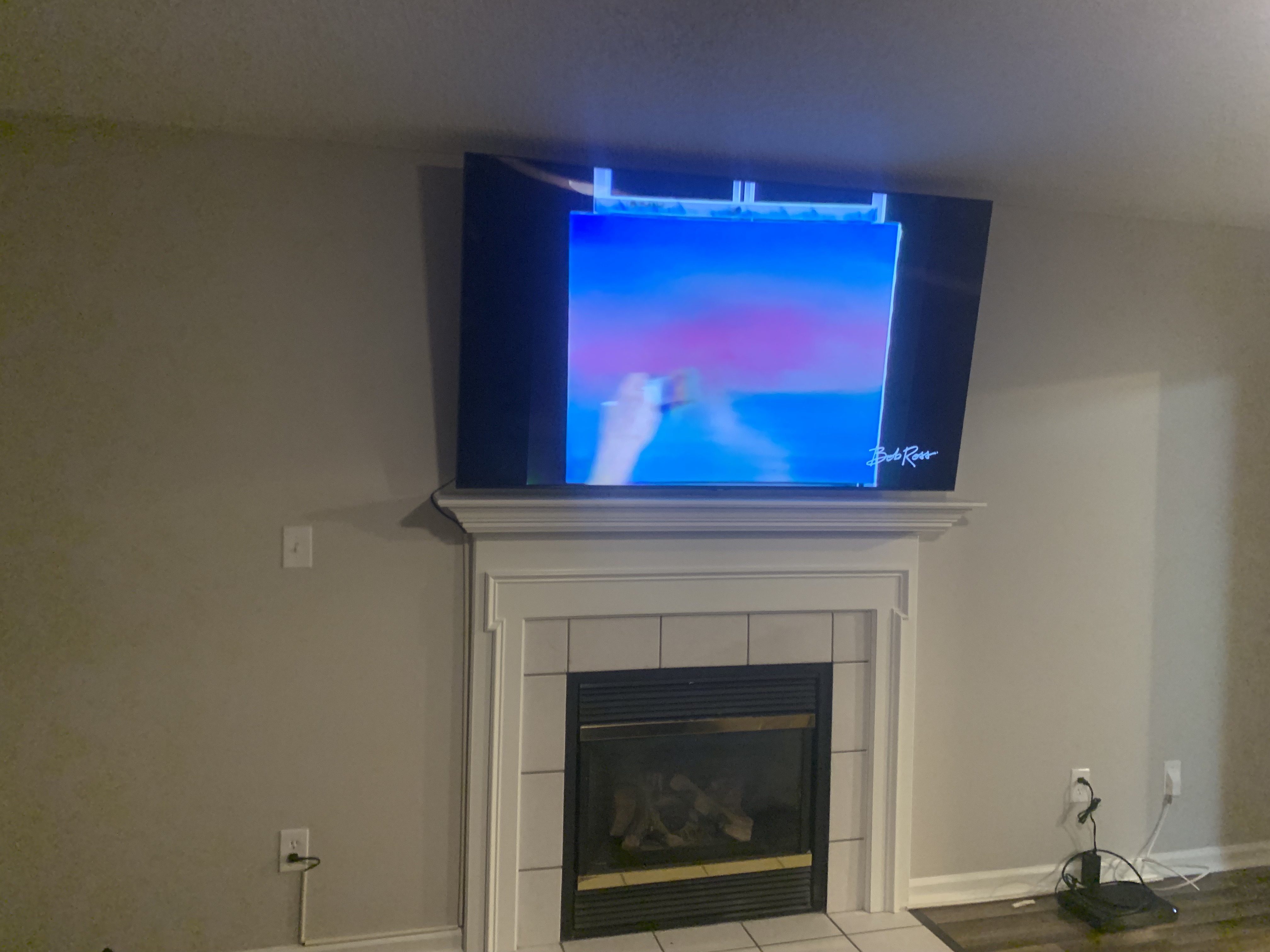 Full-motion TV mounting on drywall wall in living room, service area