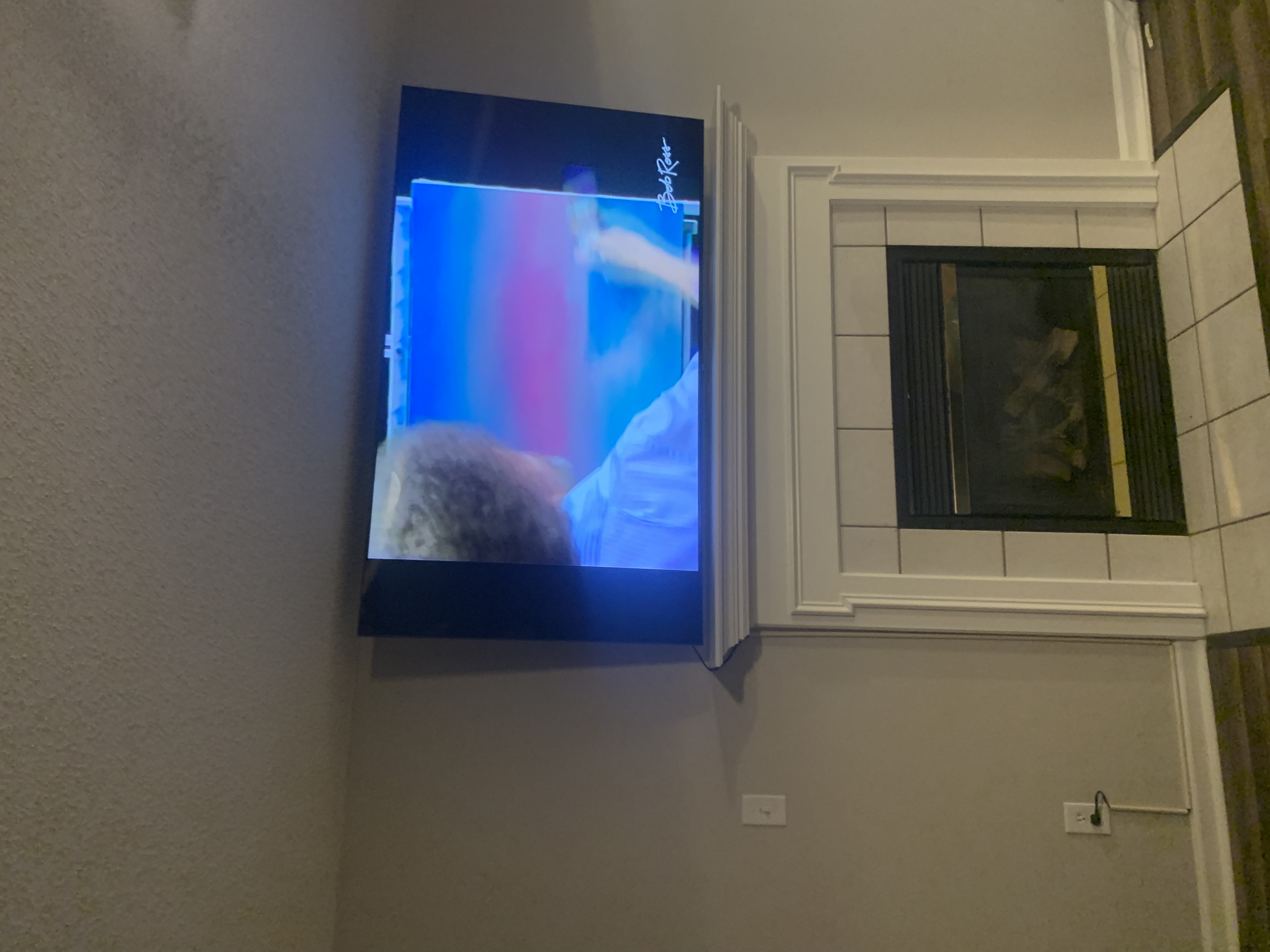 Tilting TV mounting on drywall wall in living room, service area