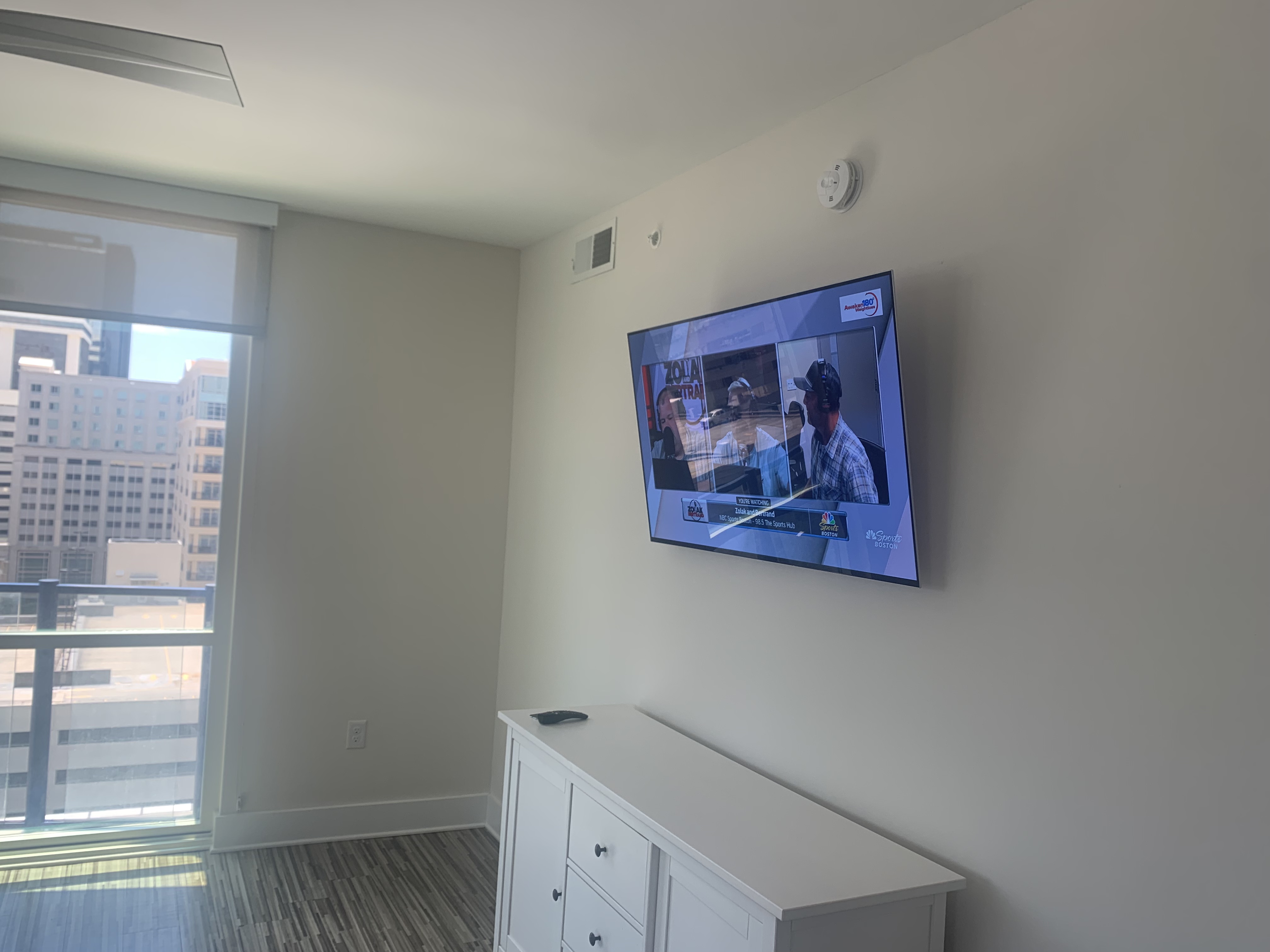 Fixed TV mounting on drywall wall in living room, service area