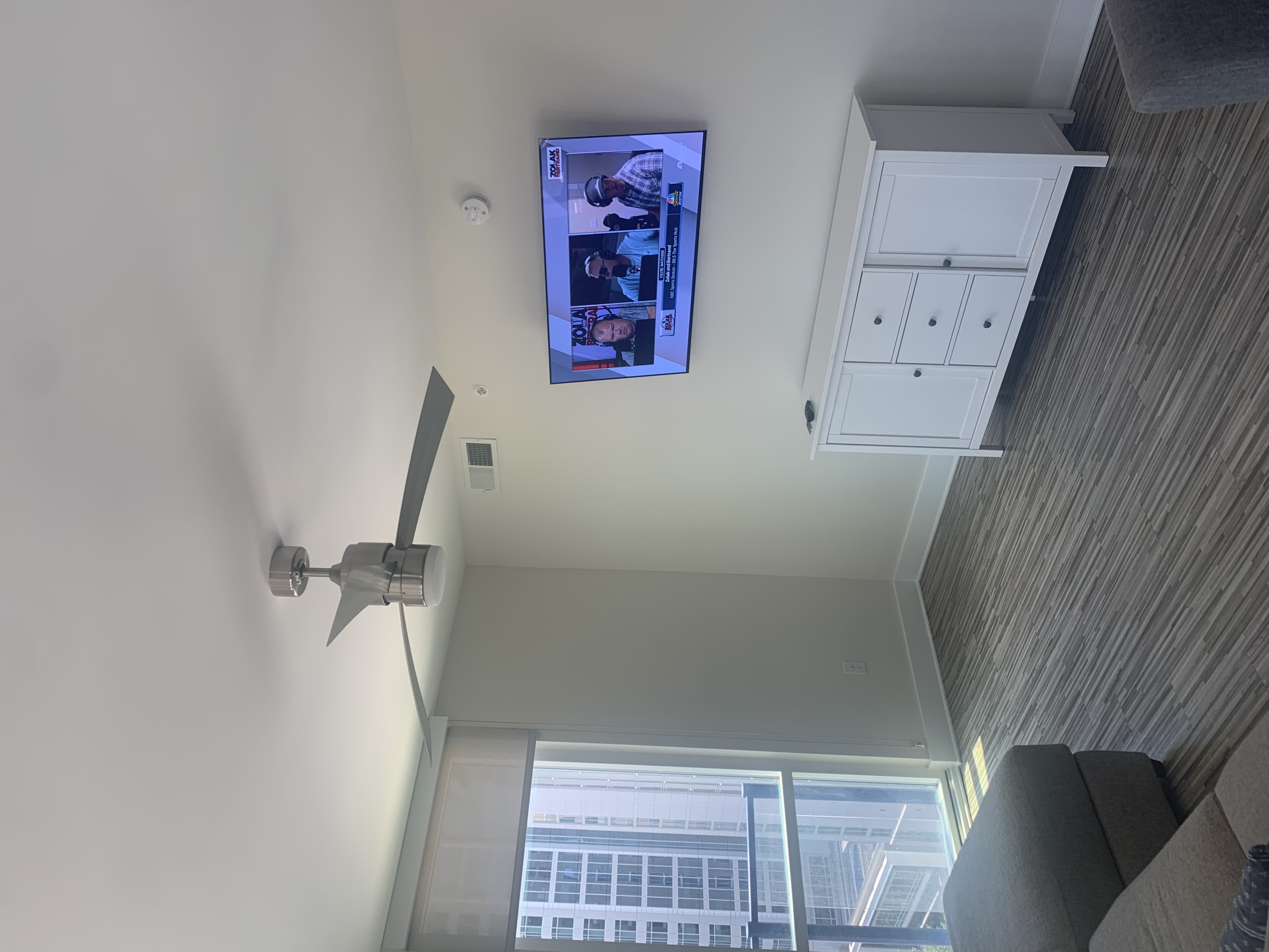 Tilting TV mounting on drywall wall in living room, service area