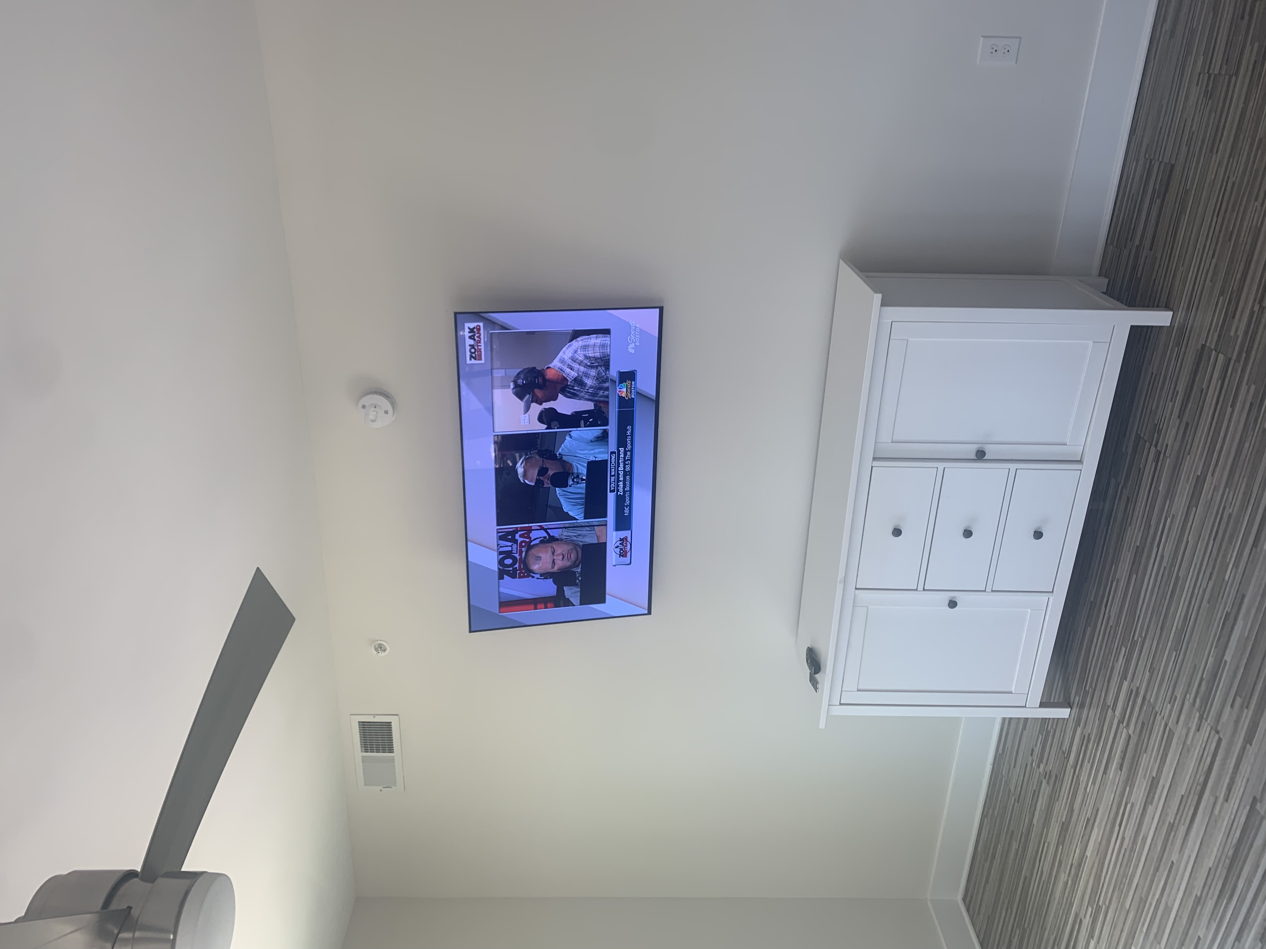 Fixed TV mounting on drywall wall in living room, service area