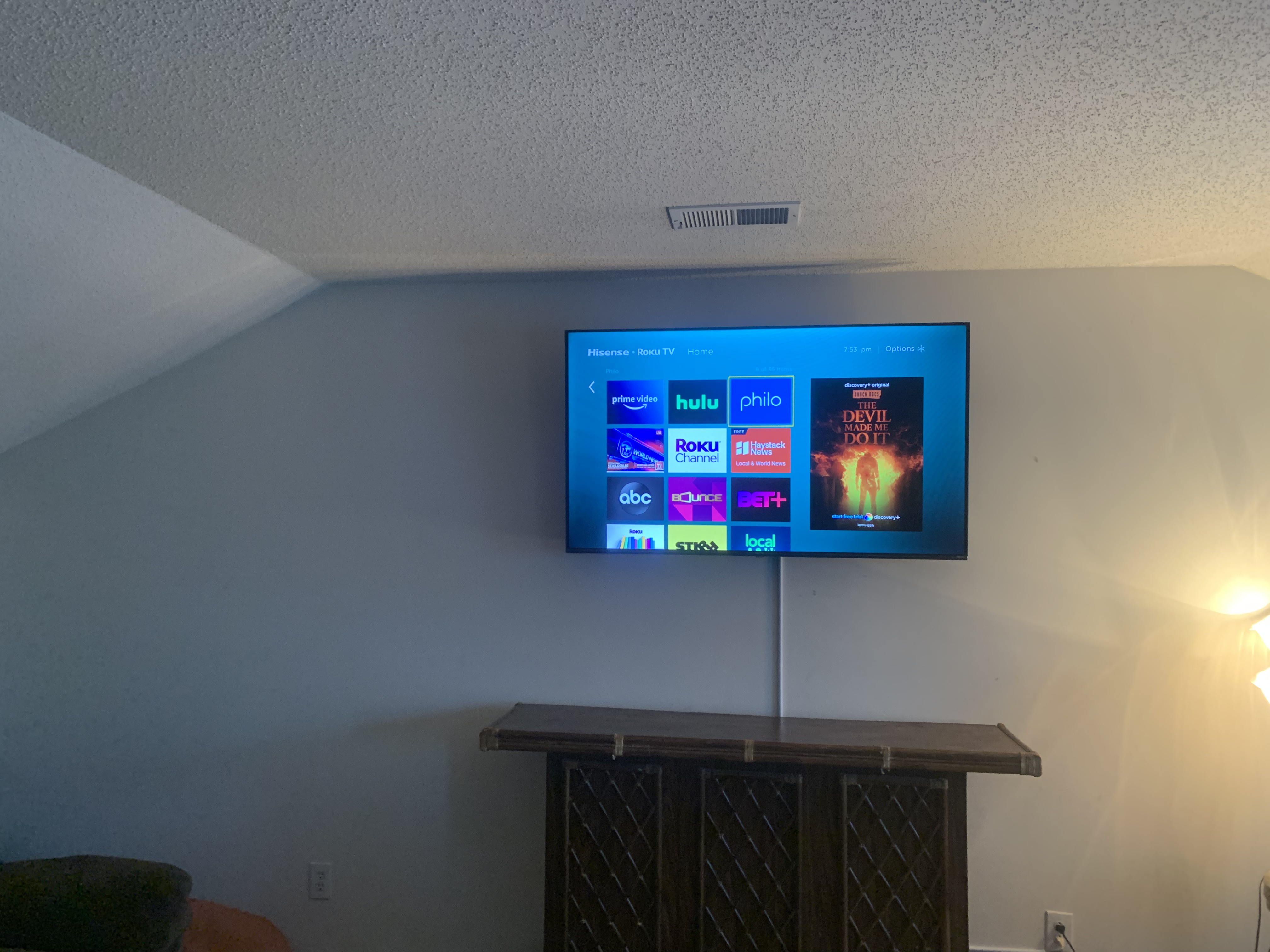 Tilting TV mounting on drywall wall in living room, service area