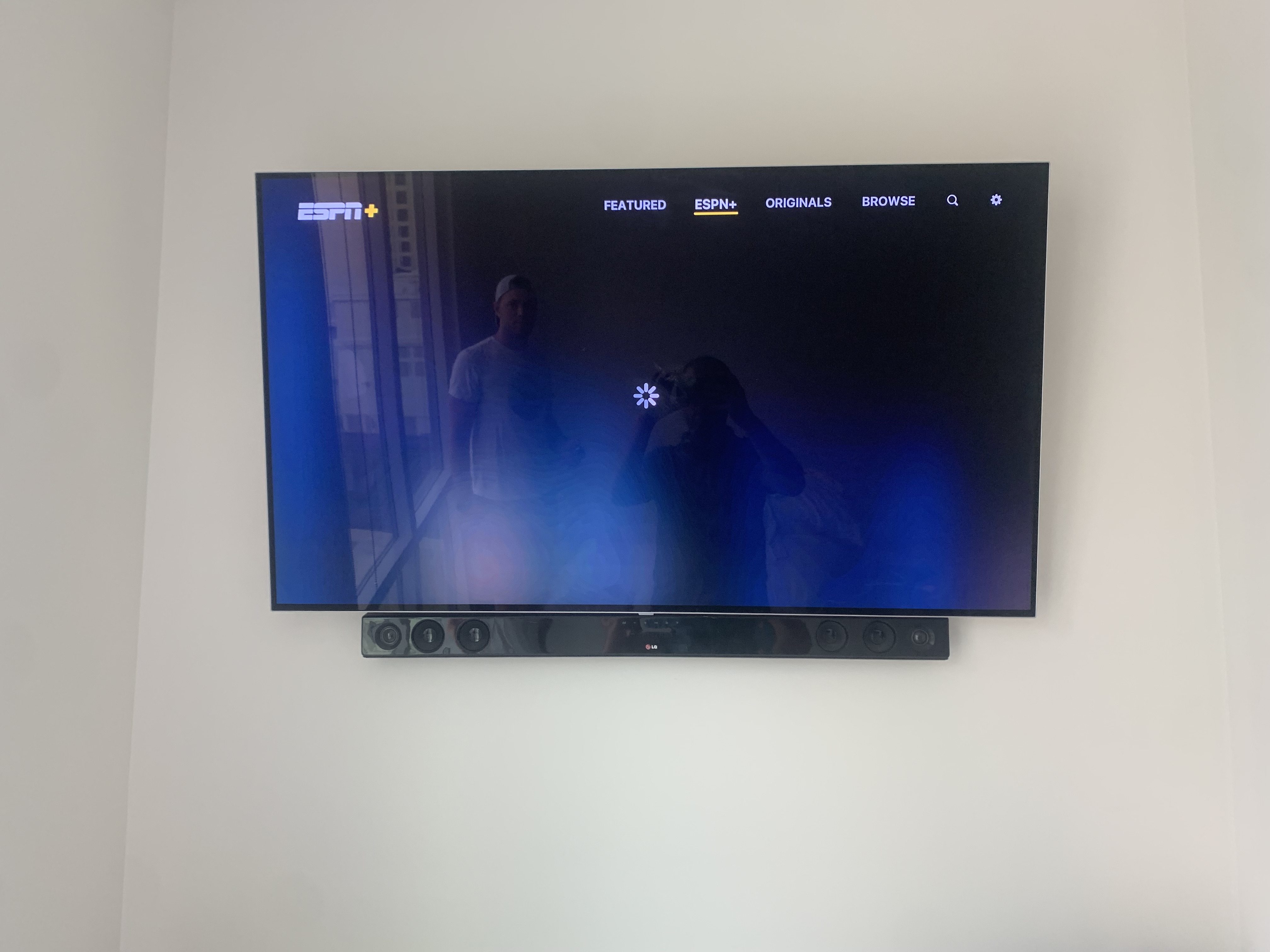 Full-motion TV mounting on drywall wall in living room, service area