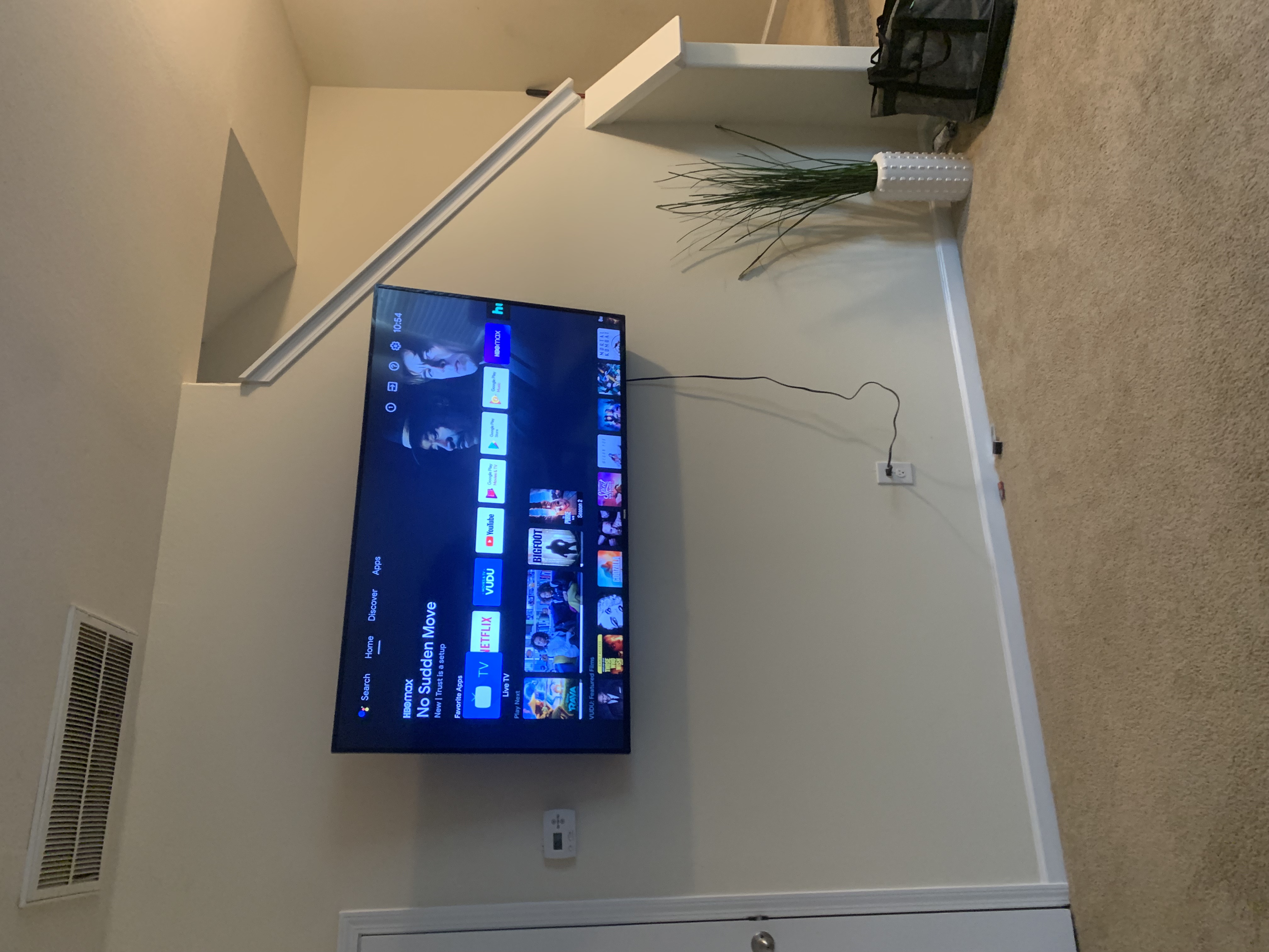 Tilting TV mounting on drywall wall in living room, service area