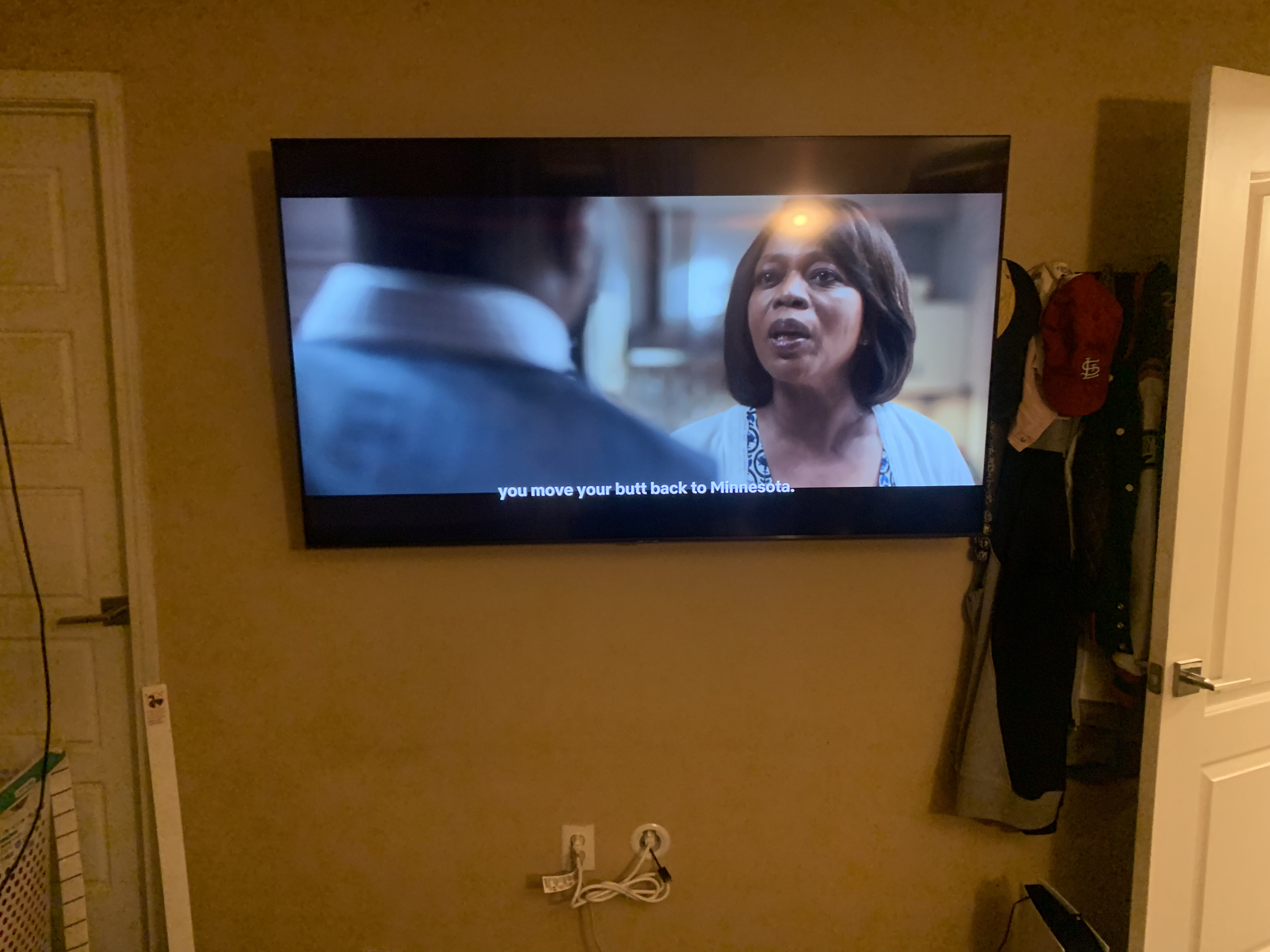 Full-motion TV mounting on drywall wall in living room, service area