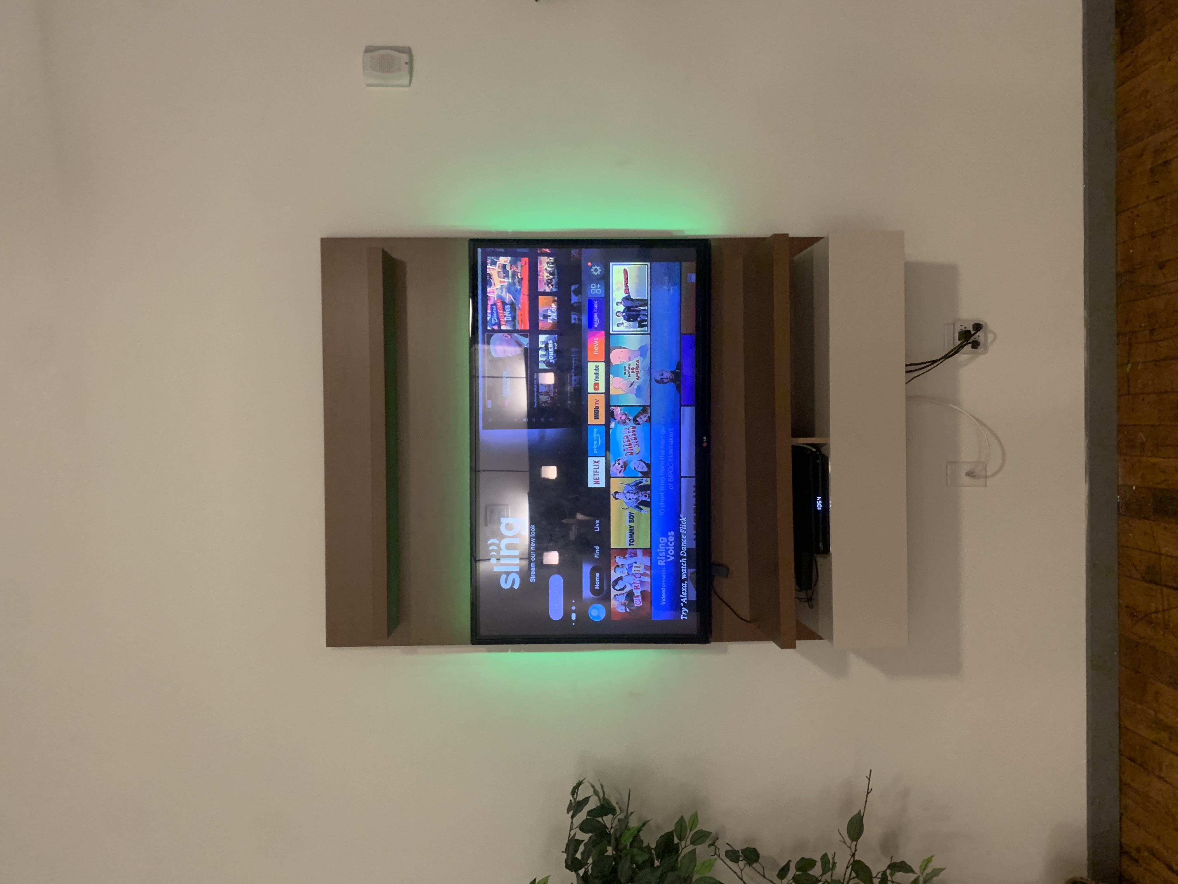 Tilting TV mounting on drywall wall in living room, service area