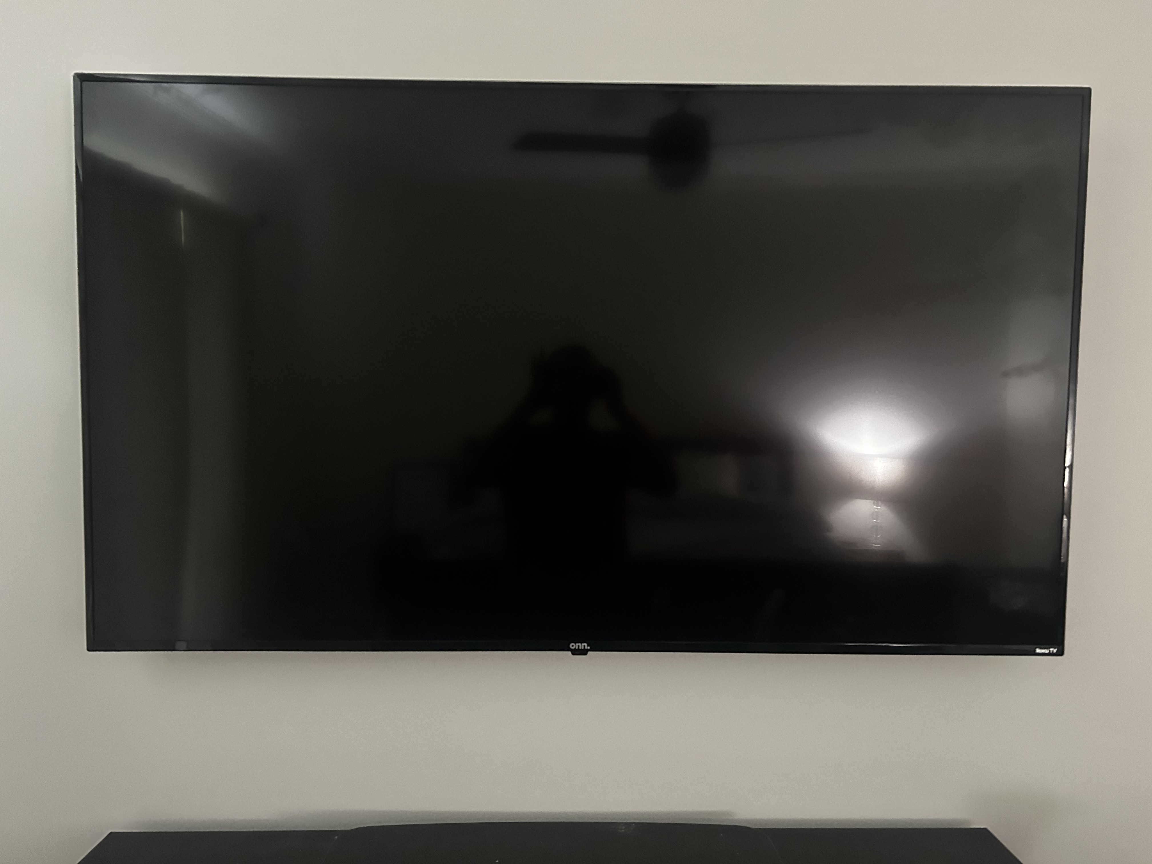 Full-motion TV mounting on drywall wall in living room, service area