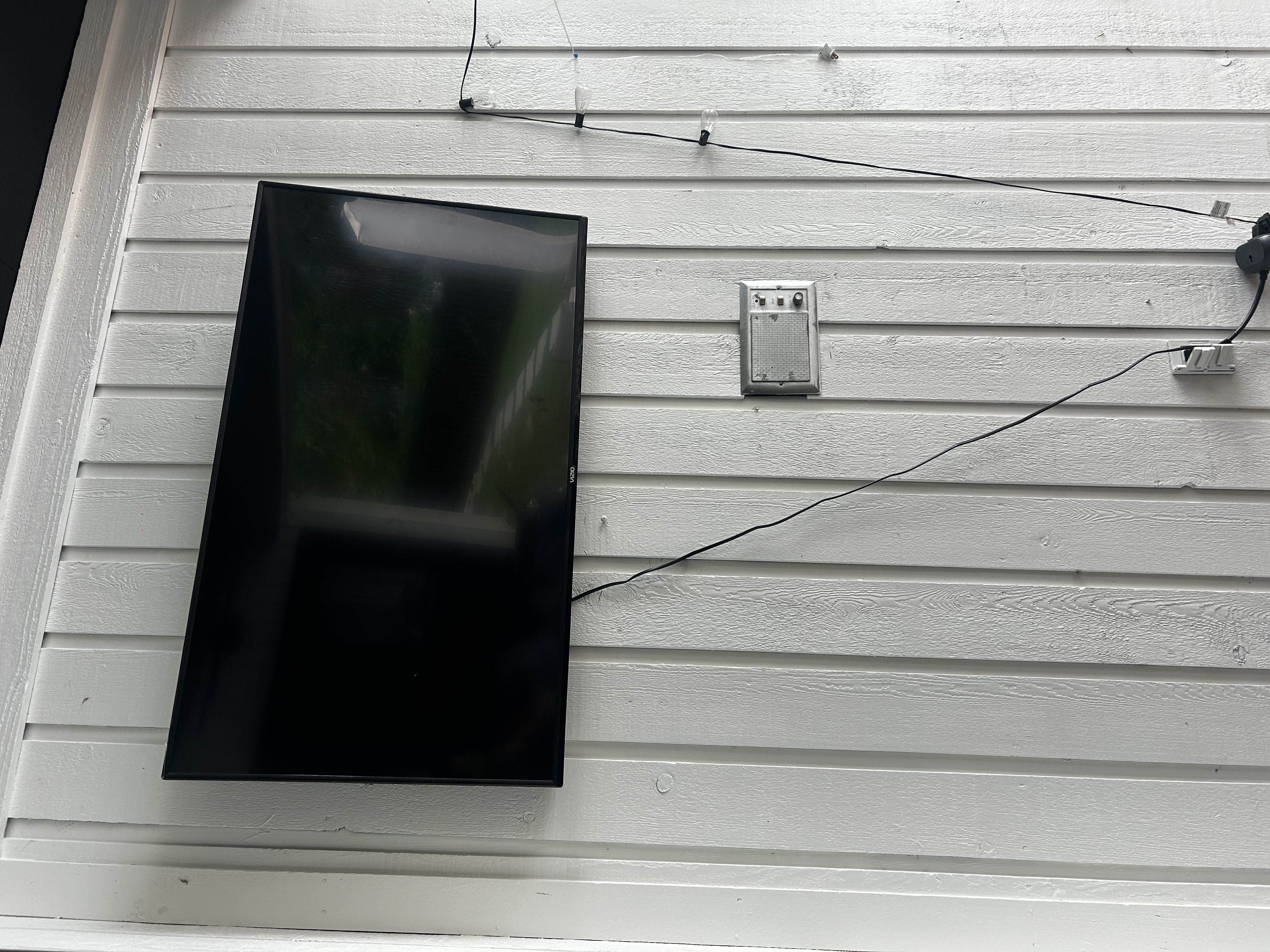 Full-motion TV mounting on drywall wall in living room, Charlotte NC