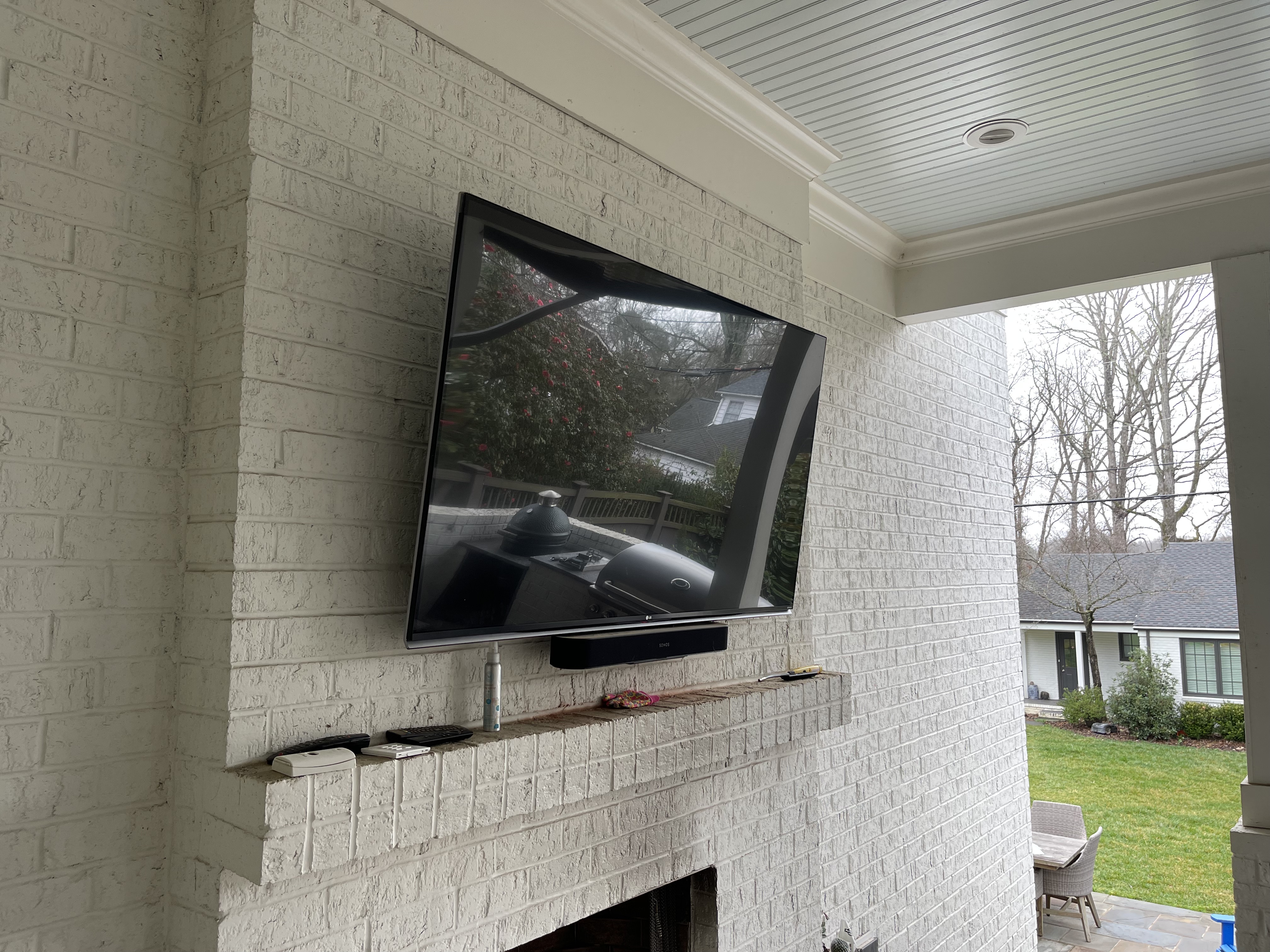 Tilting TV mounting on drywall wall in living room, service area
