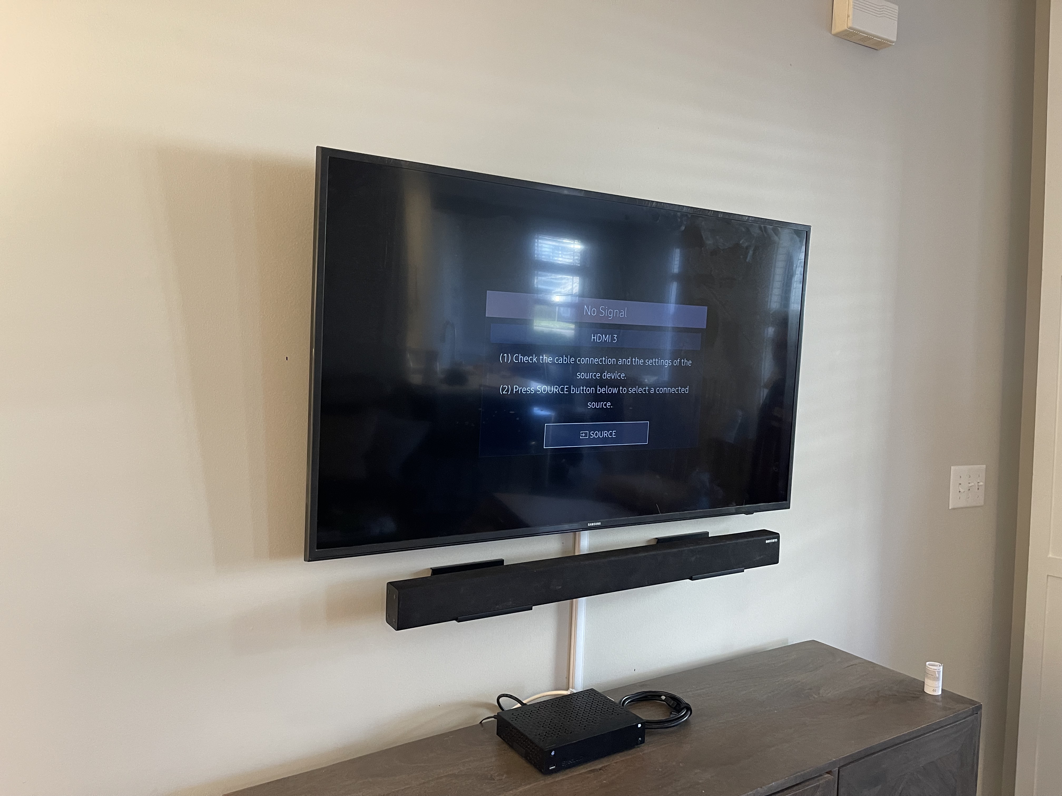 Tilting TV mounting on drywall wall in living room, service area