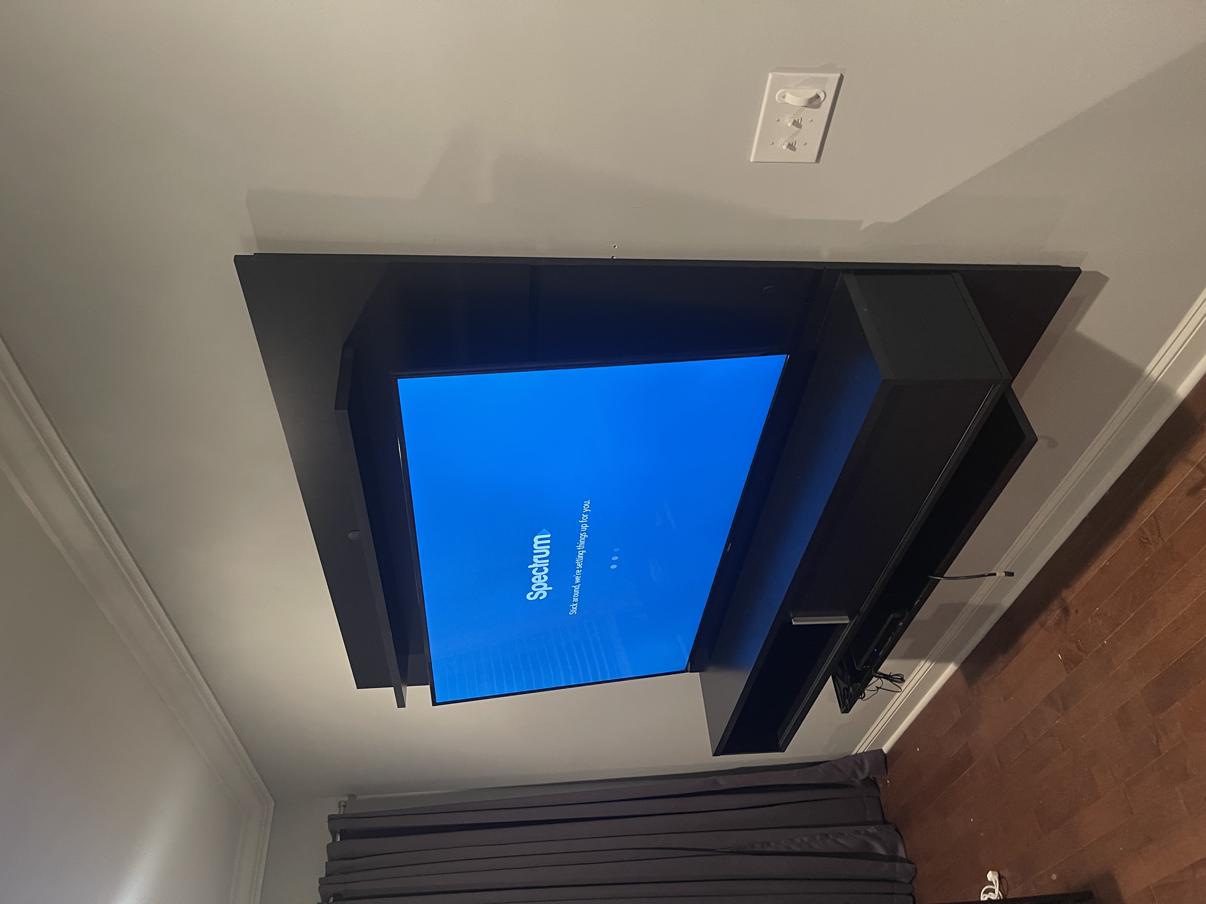 Fixed TV mounting on drywall wall in living room, service area