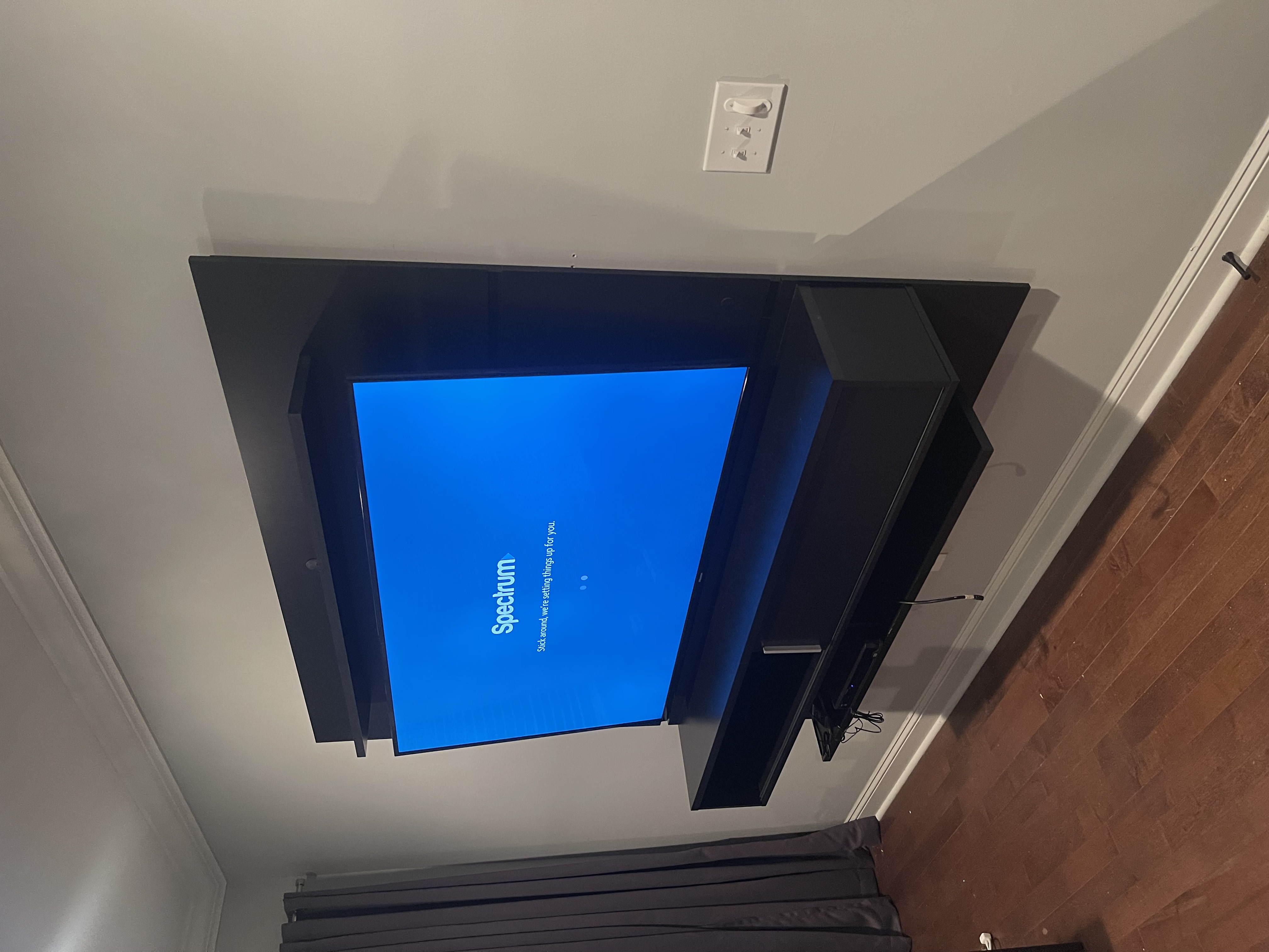 Tilting TV mounting on drywall wall in living room, service area