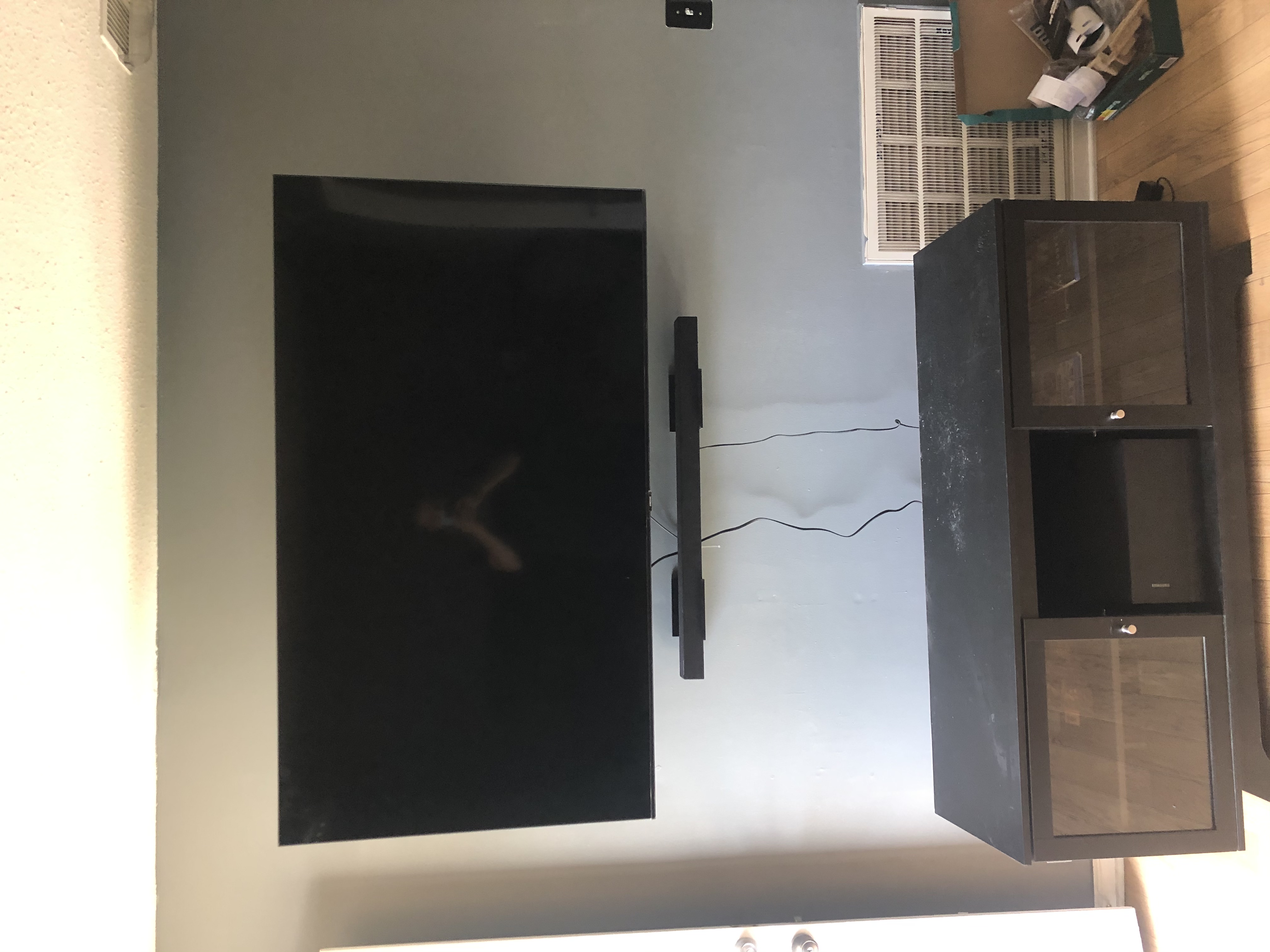 Fixed TV mounting on drywall wall in living room, service area