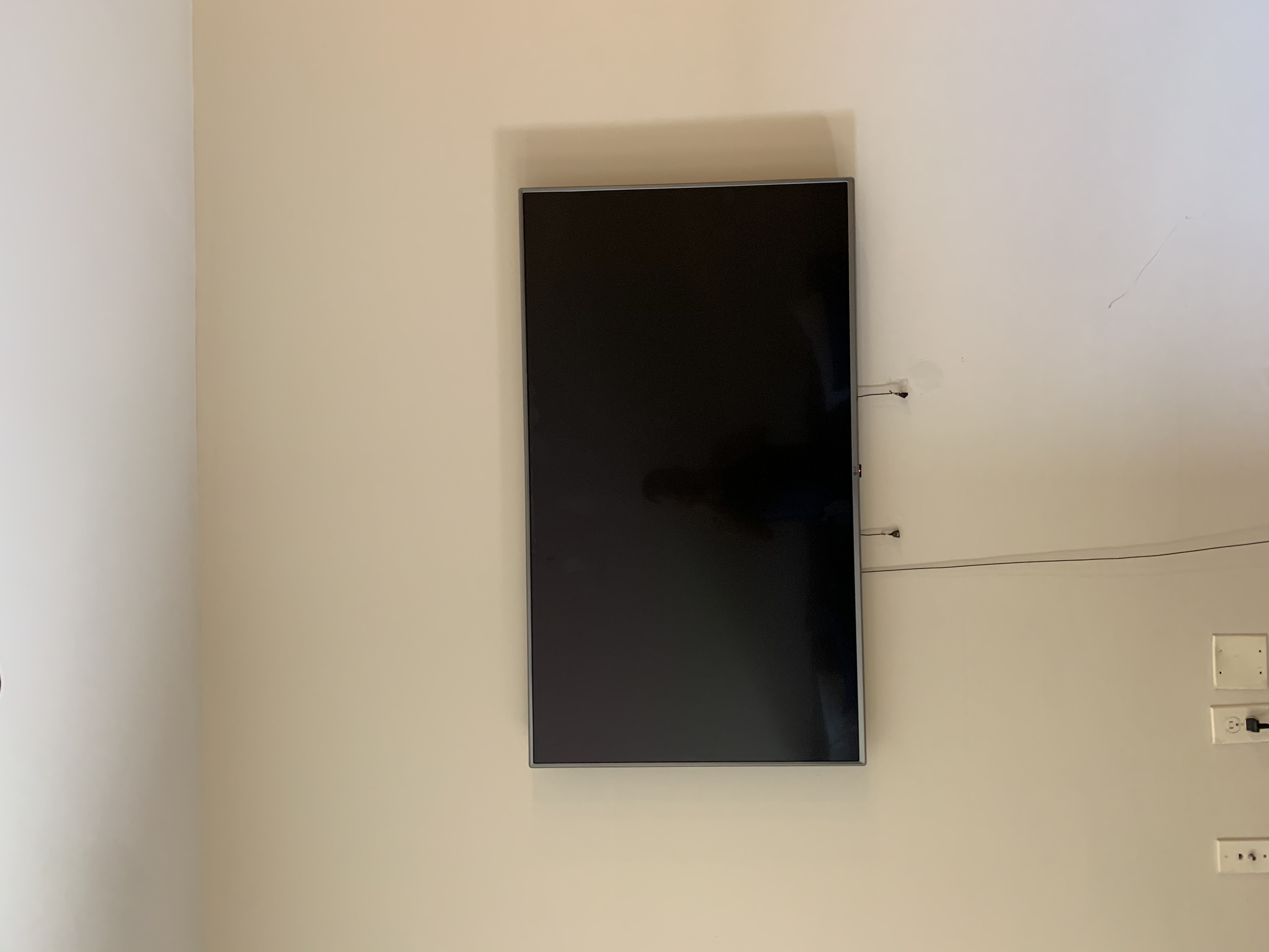Full-motion TV mounting on drywall wall in living room, Columbia SC