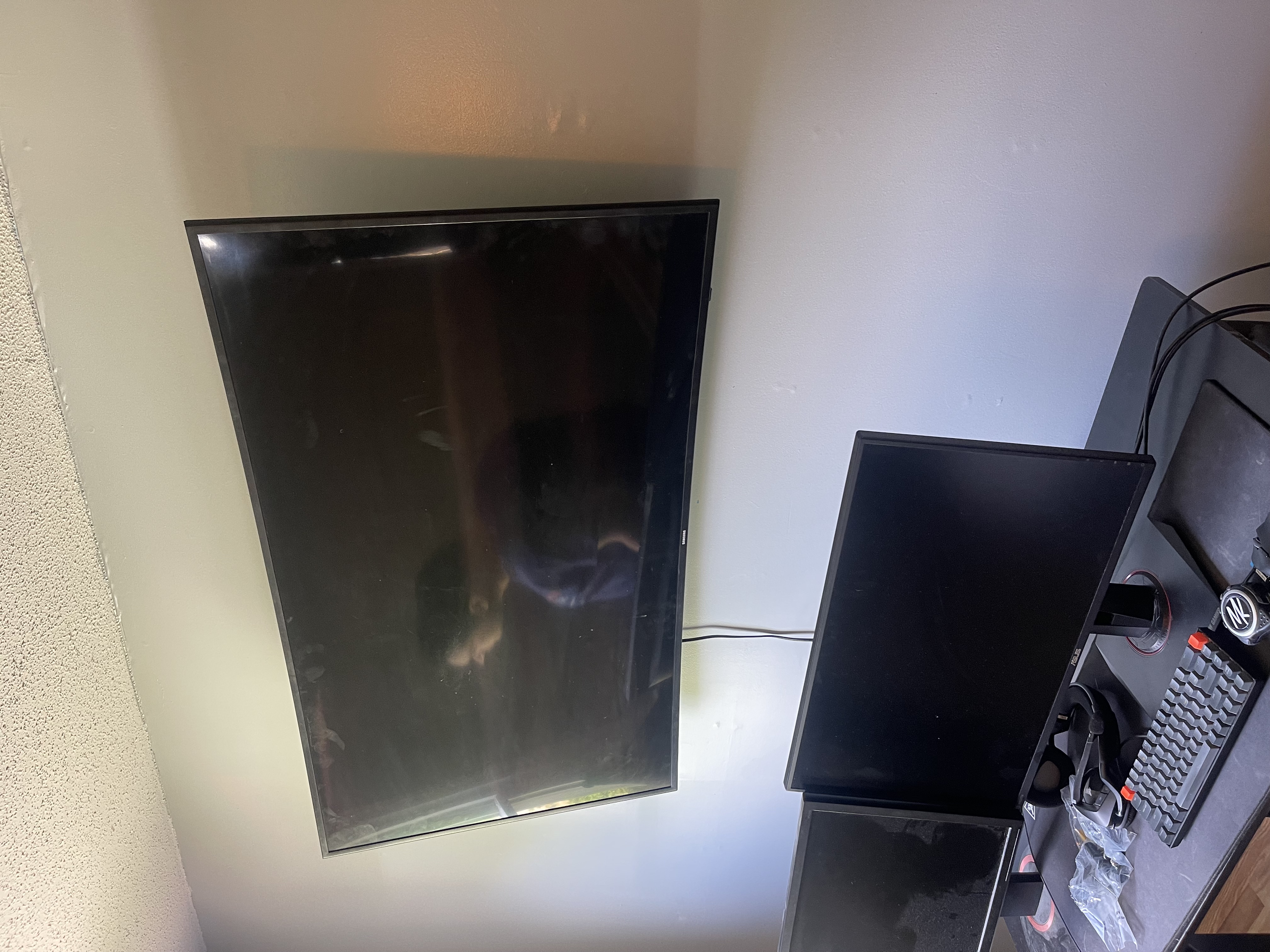 Full-motion TV mounting on drywall wall in living room, service area