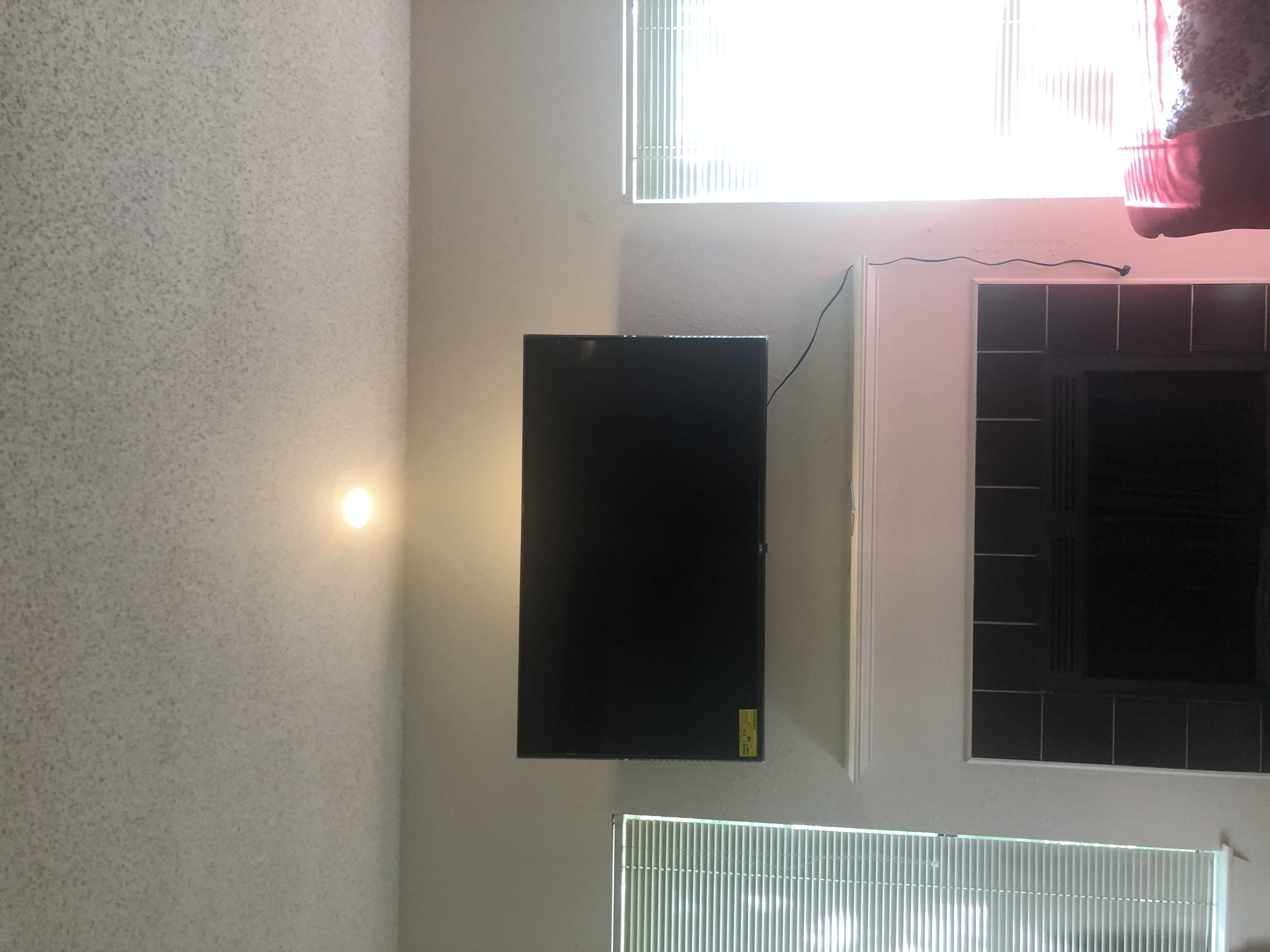 Fixed TV mounting on drywall wall in living room, service area