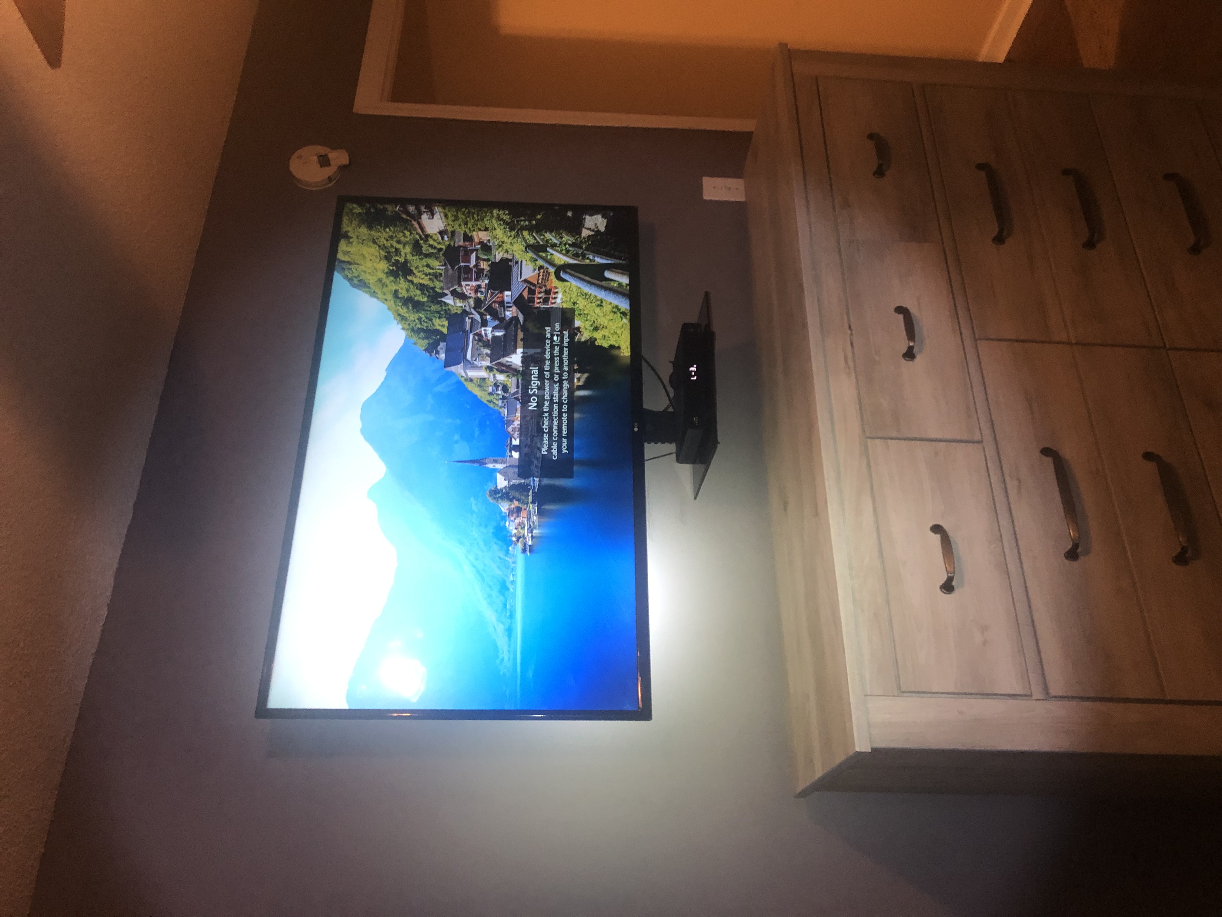 Tilting TV mounting on drywall wall in living room, service area