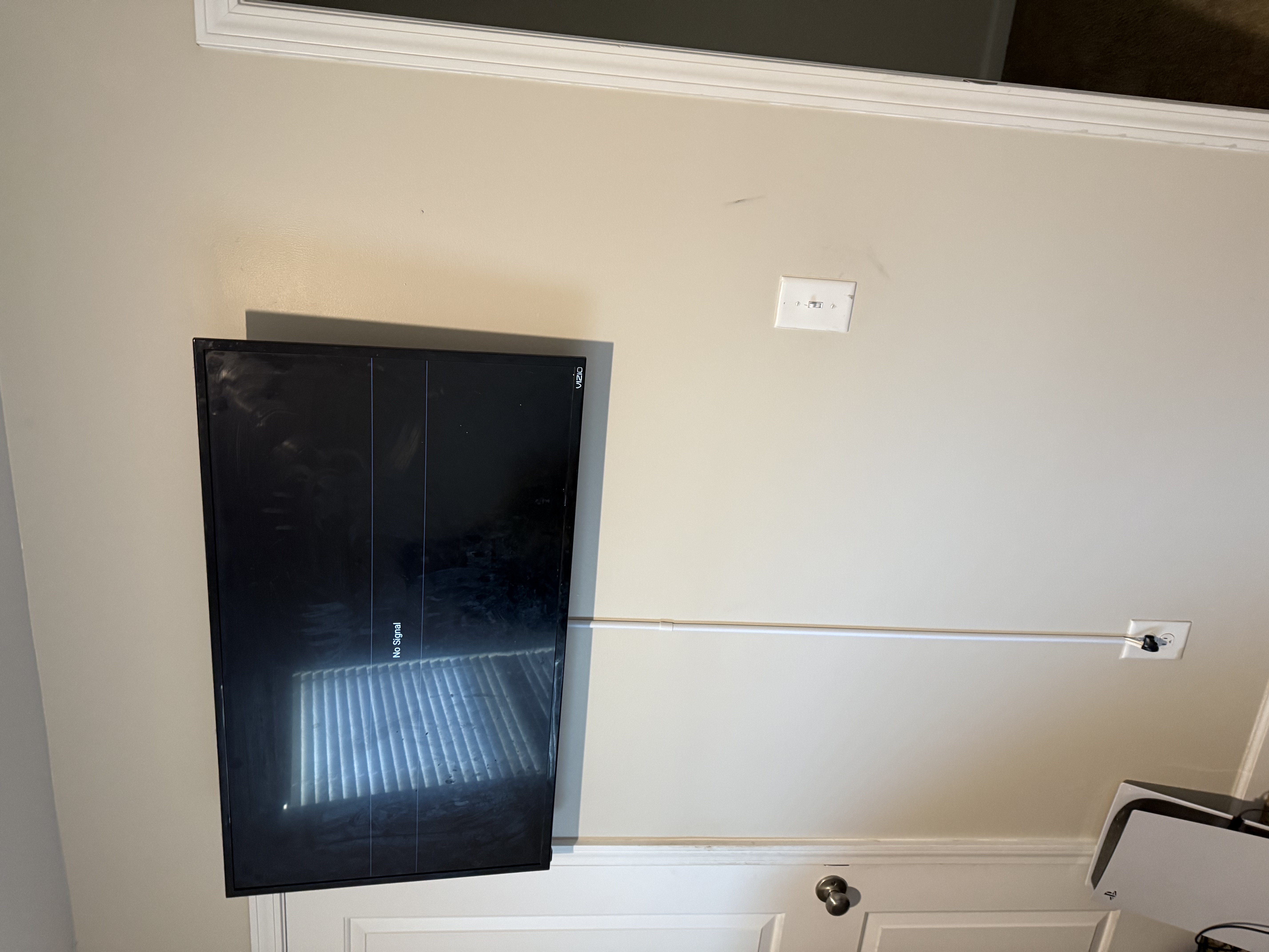 Full-motion TV mounting on drywall wall in living room, service area