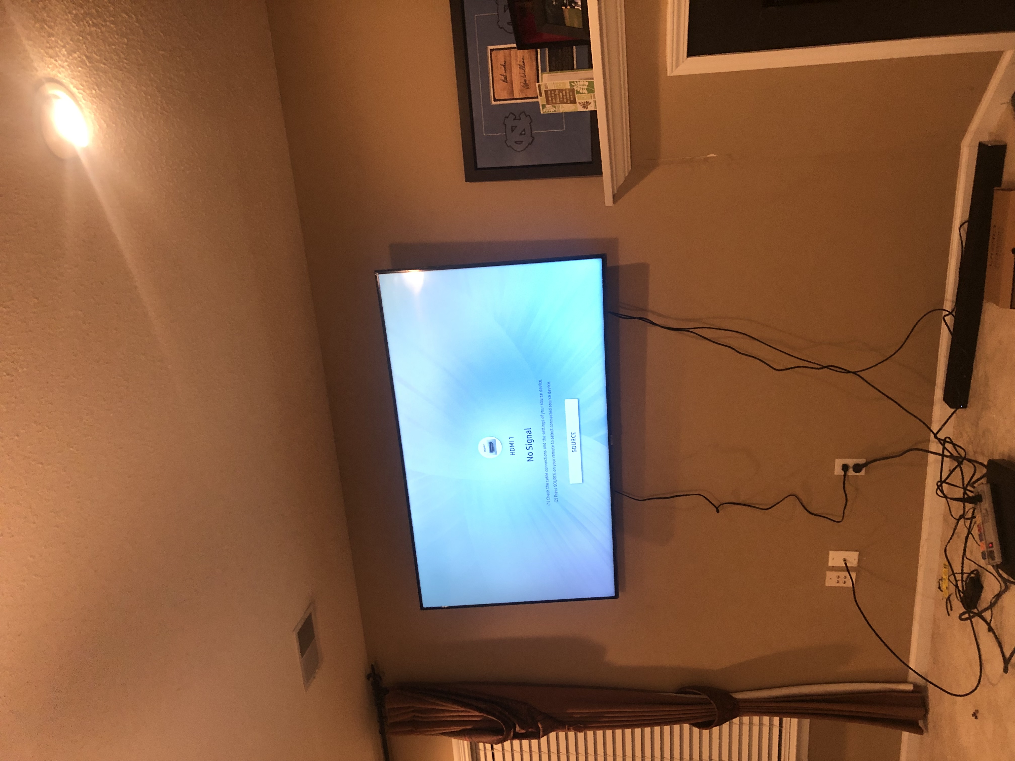 Tilting TV mounting on drywall wall in living room, service area